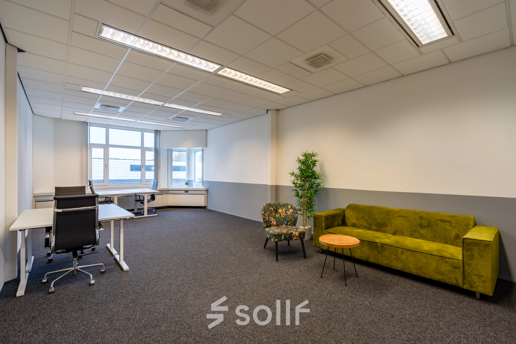 Spacious office to rent at Touwbaan 38, Leiderdorp, featuring a bright area with a green sofa, floral chair, and modern desks for office space rental.