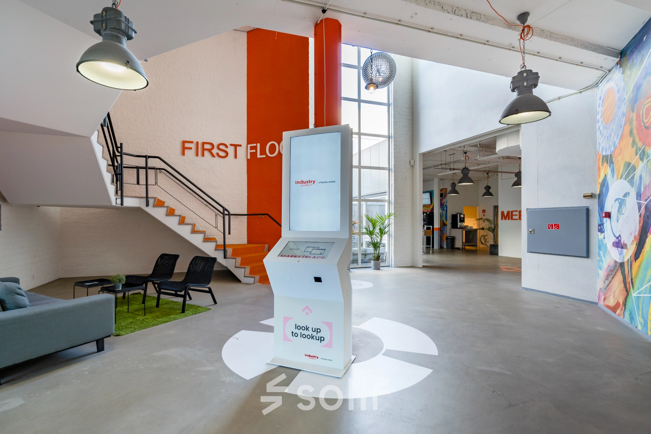 Modern, inviting office entrance at Touwbaan 38 in Leiderdorp, featuring sleek seating and a digital kiosk, ideal for businesses seeking office space rental with a contemporary feel.