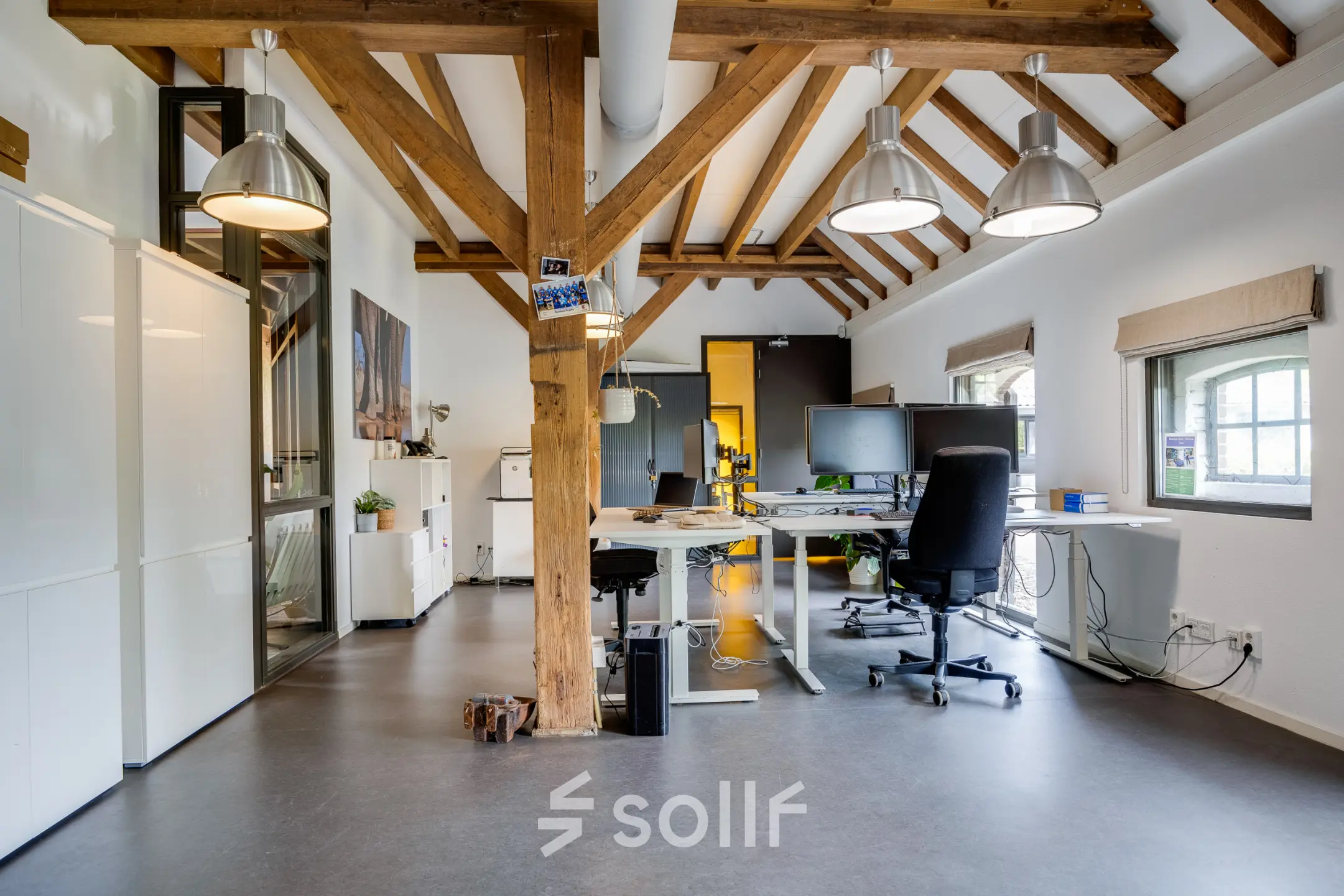 Spacious office space at Hamersveldseweg 120, Leusden, featuring modern desks and exposed wooden beams, available for rent. Ideal for office space rental.