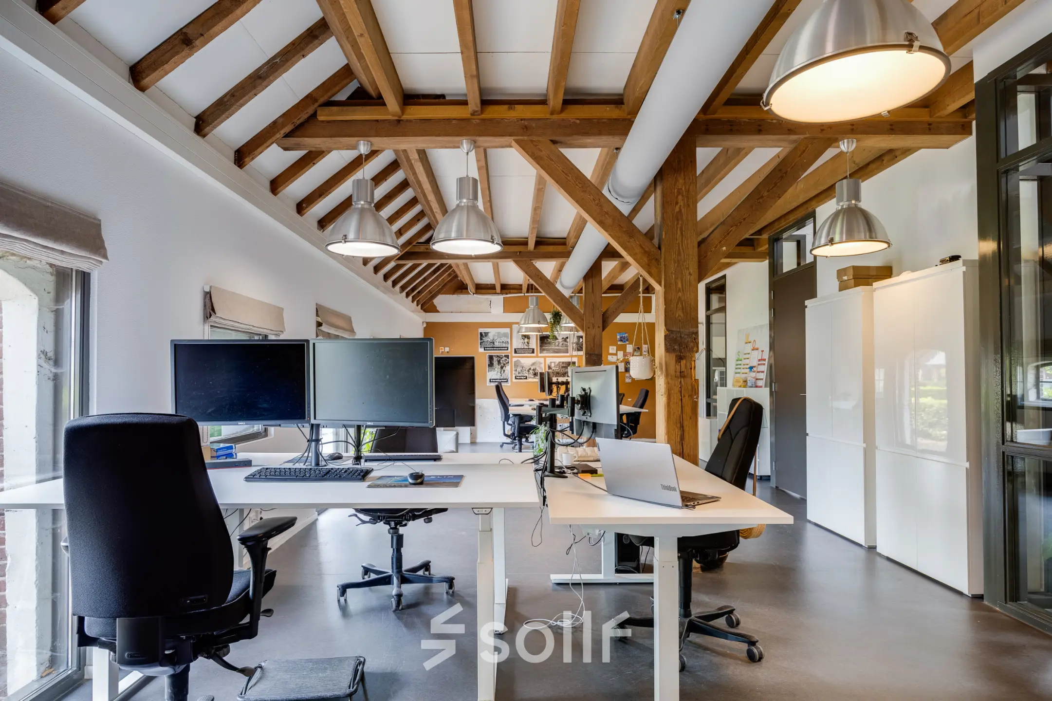 Interior view of office space rental at Hamersveldseweg 120, Leusden, featuring modern workspaces with wooden beam ceiling.