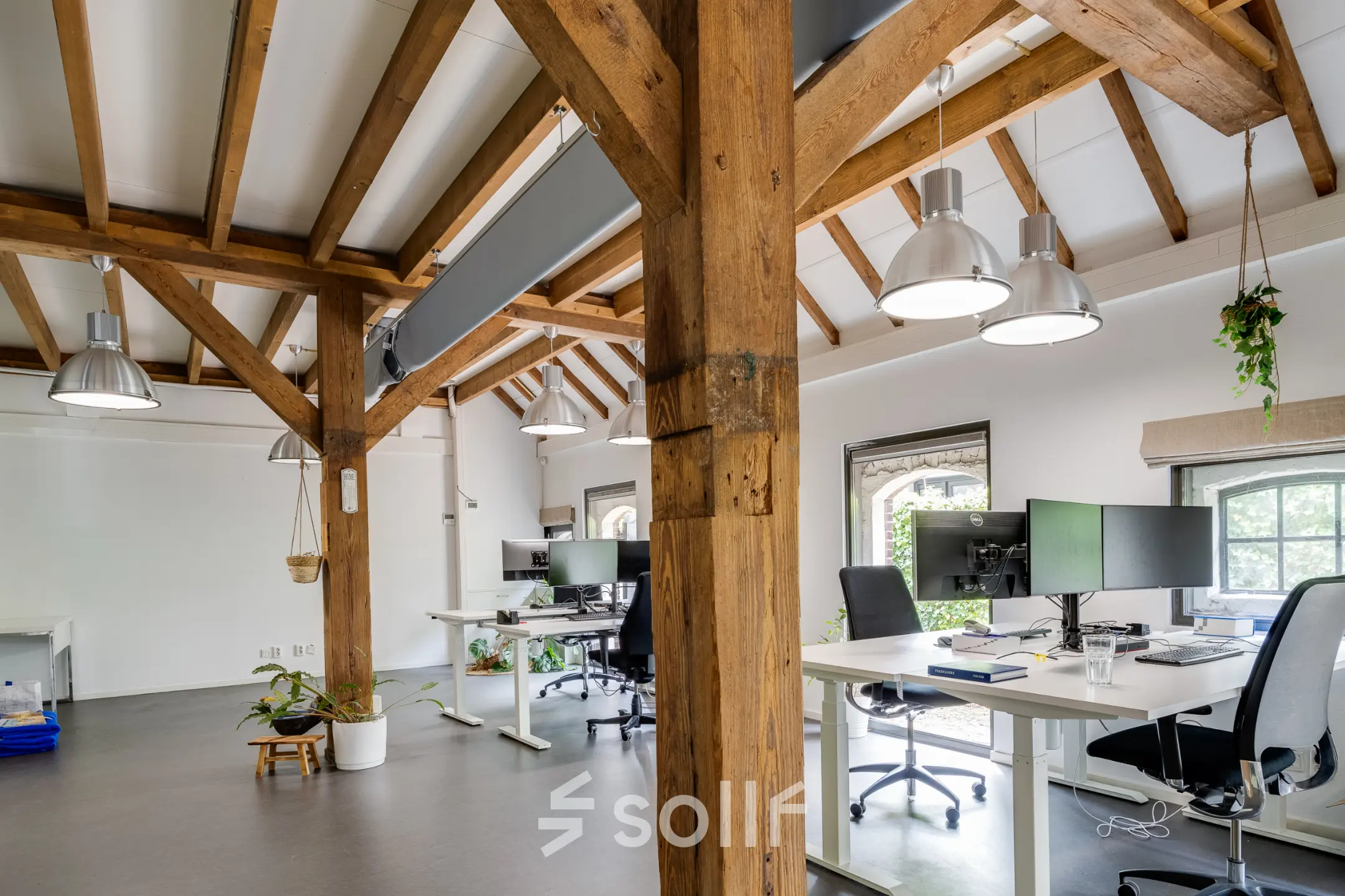 Bright office space at Hamersveldseweg 120, Leusden, with wooden beams, desks, and natural light, ideal for office space rental.