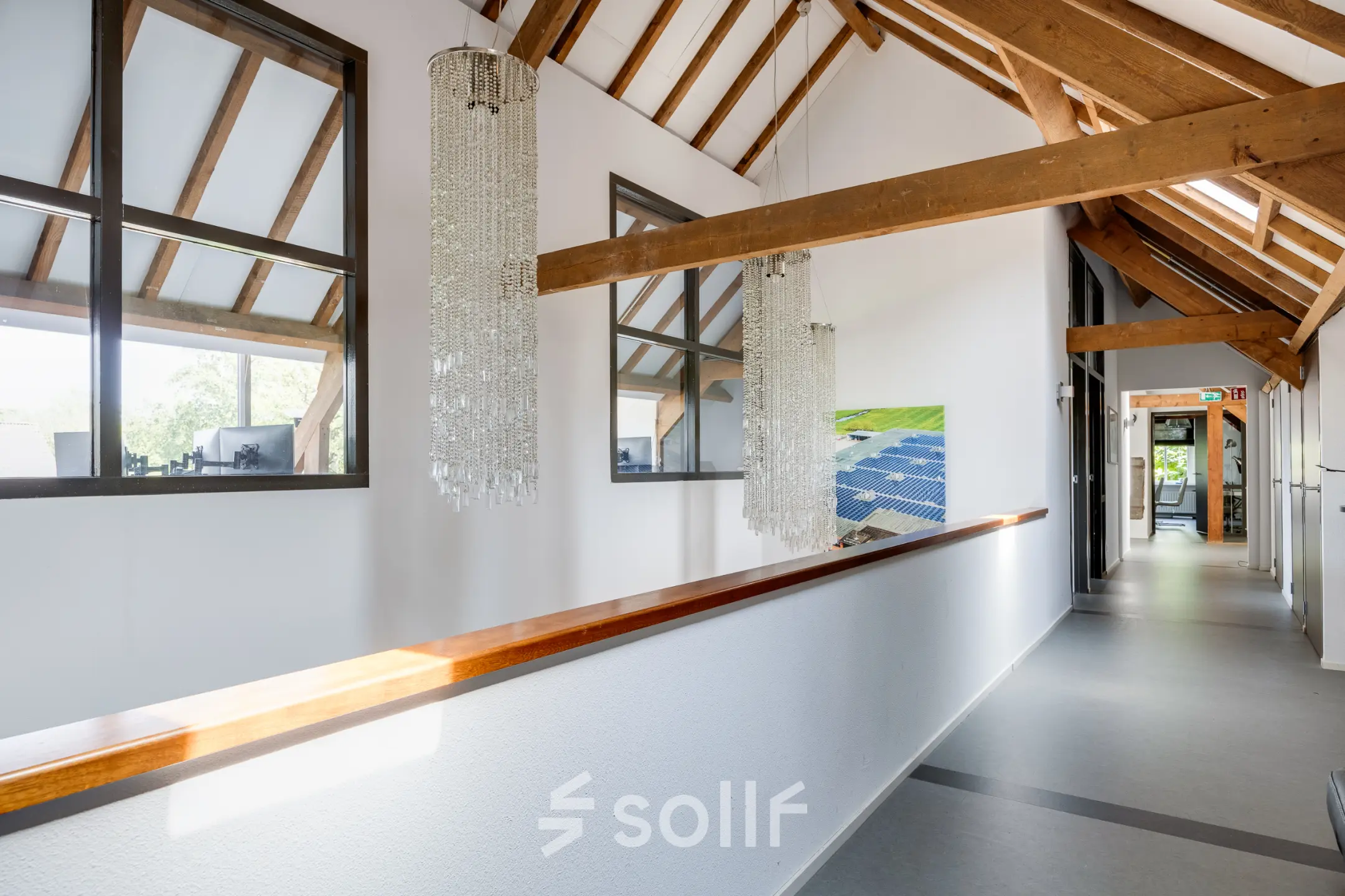Bright office corridor with wooden beams and chandeliers at Hamersveldseweg 120, Leusden, available for office space rental.