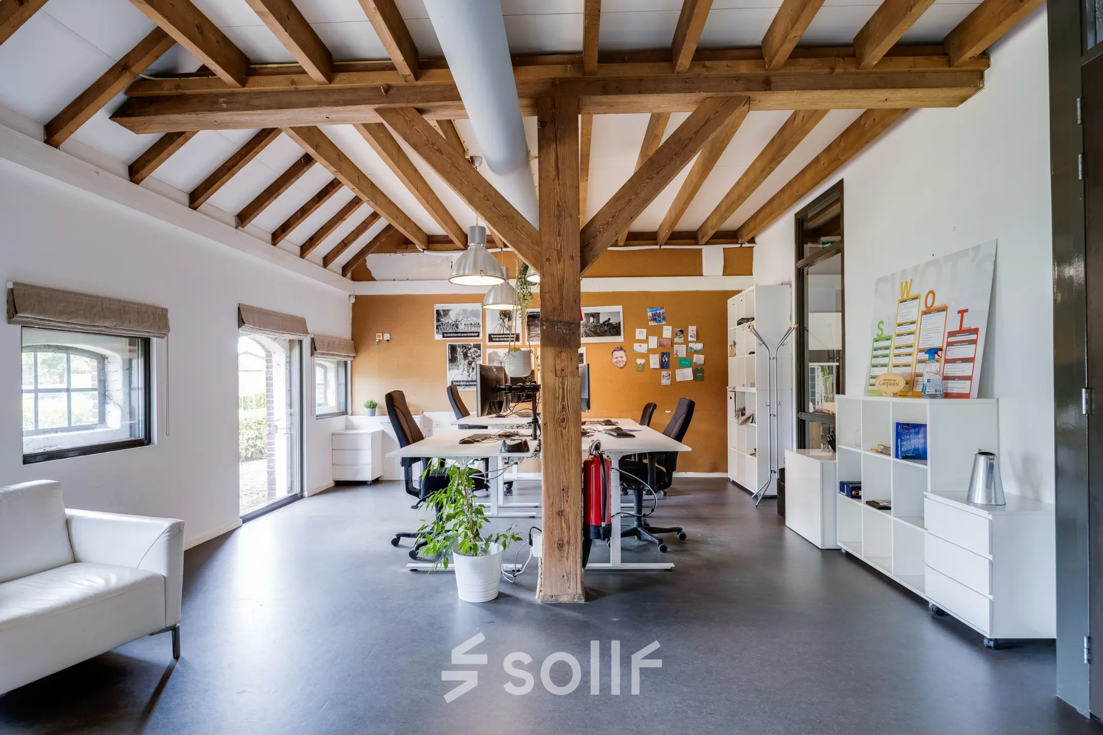Spacious office at Hamersveldseweg 120, Leusden with exposed beams, modern furnishings, and natural light. Perfect for office space rental with a mix of collaborative and private work areas.