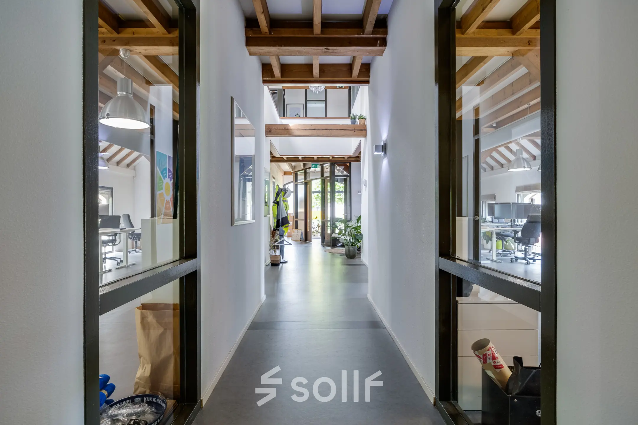 Bright office space with wooden beams, plants, and modern furnishings on Hamersveldseweg 120, ideal for businesses seeking office space rental in Leusden.
