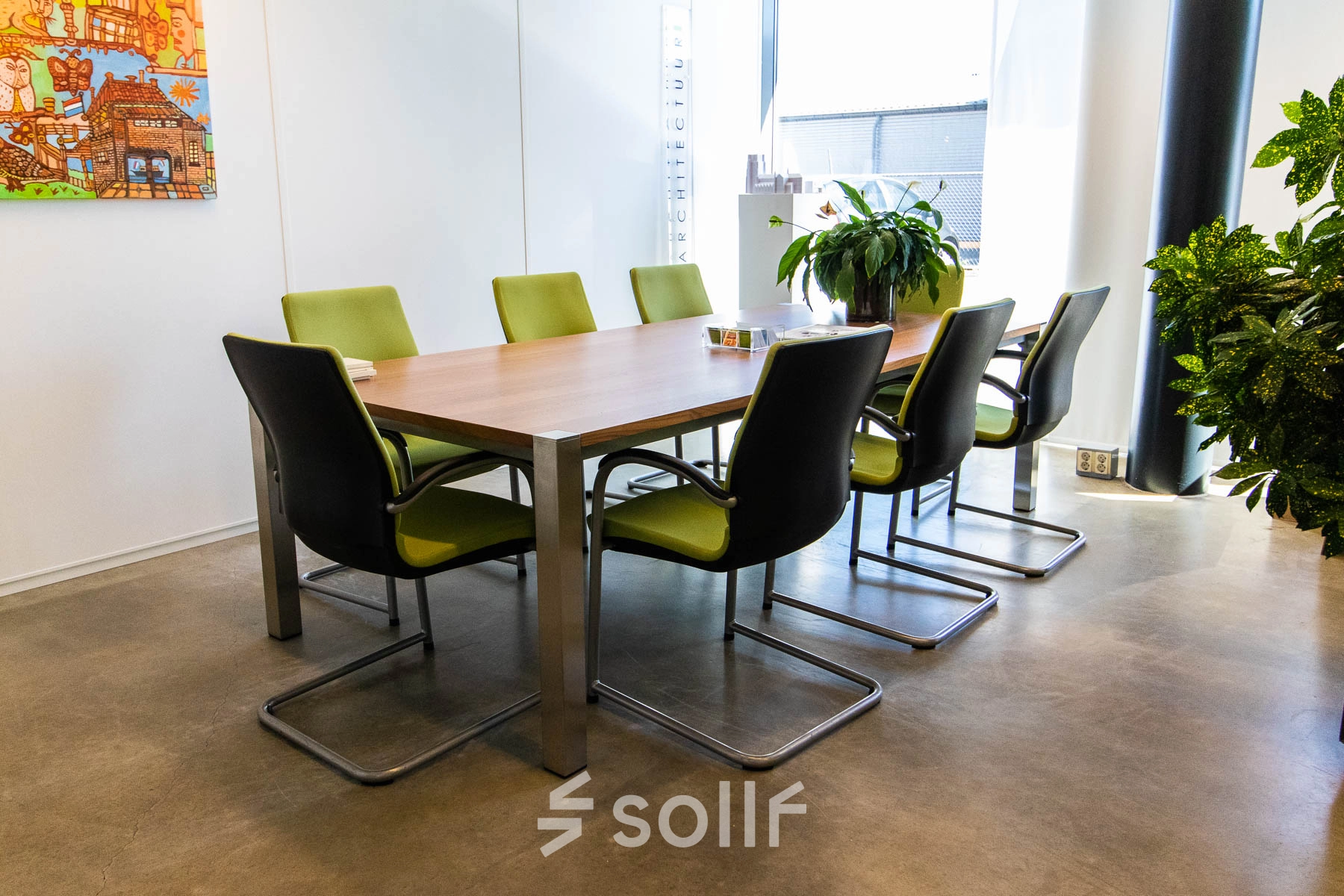 Bright office space with a modern table and green chairs, ideal for office space rental at Brieltjenspolder 28, Made.