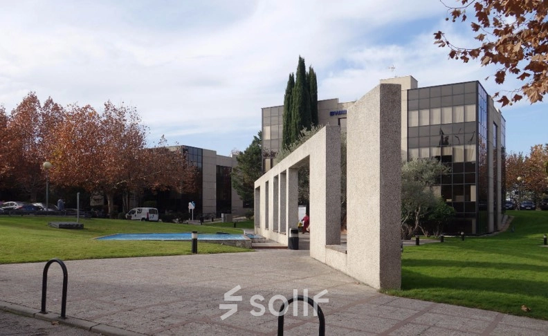 Modern office buildings at Calle de la Azalea 1 in Madrid Alcobendas, featuring sleek glass facades and landscaped greenery, ideal for office space rental.