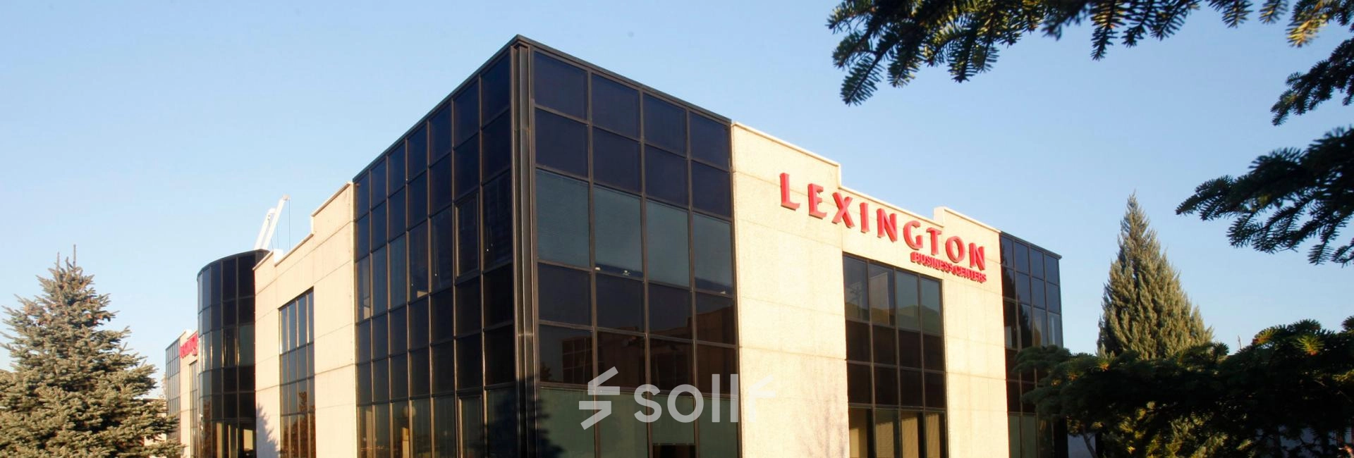 Exterior view of office space available for rent at Calle de la Caléndula 93, Madrid Alcobendas, showcasing a modern facade with large windows.