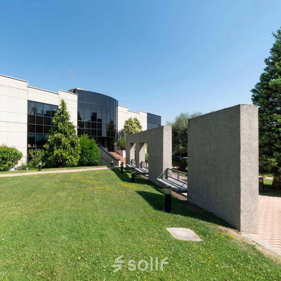 Exterior view of an office building located at Calle de la Caléndula 93 in Madrid Alcobendas, perfect for rent office space with modern glass facade and surrounding greenery.