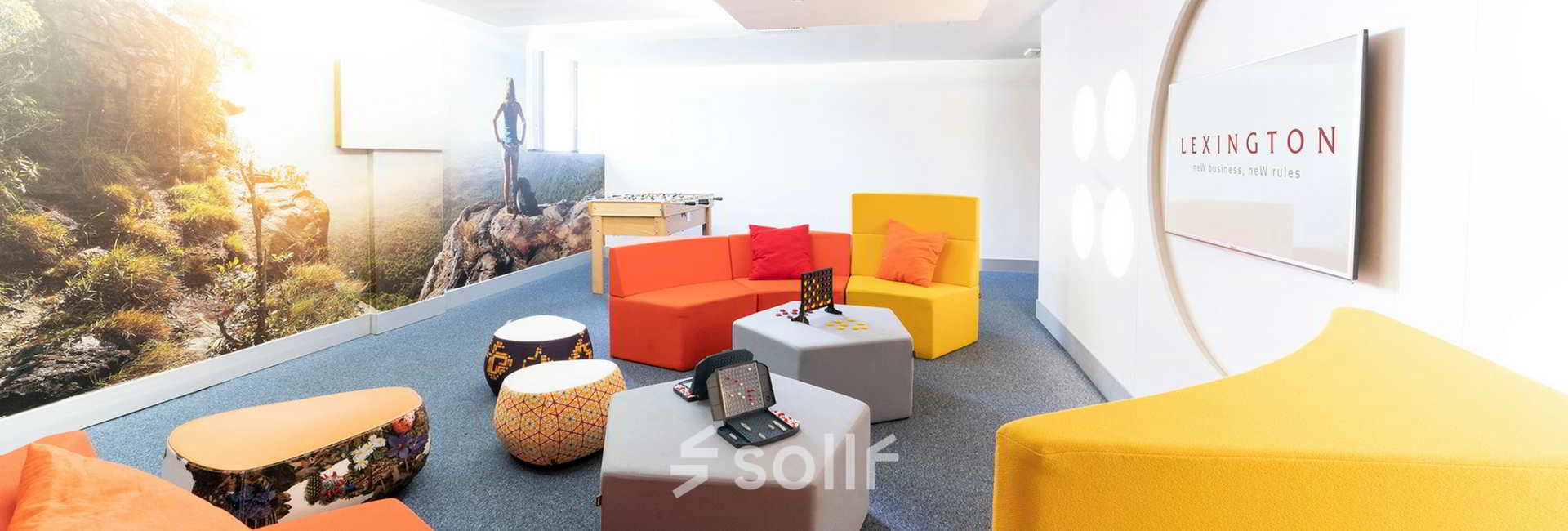 Colorful, modern office space at Calle de la Caléndula 93 in Madrid Alcobendas, featuring vibrant seating and a foosball table, ideal for rent office space or office space rental.