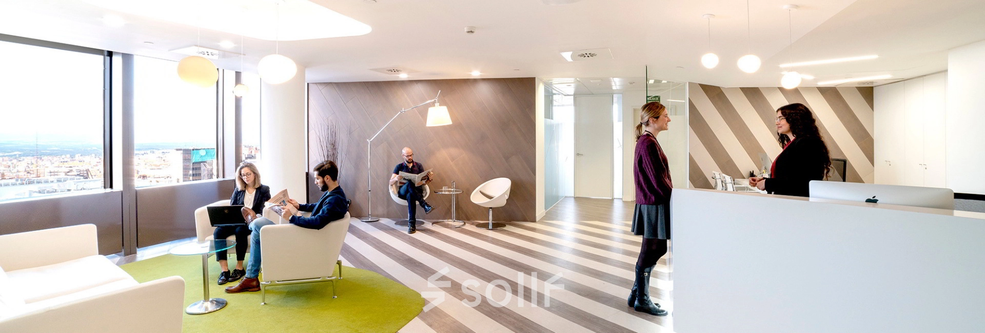 Bright and modern office space at Paseo de la Castellana 141, Madrid Azca, featuring a reception area with people collaborating. Ideal for office space rental with a stylish and functional design.