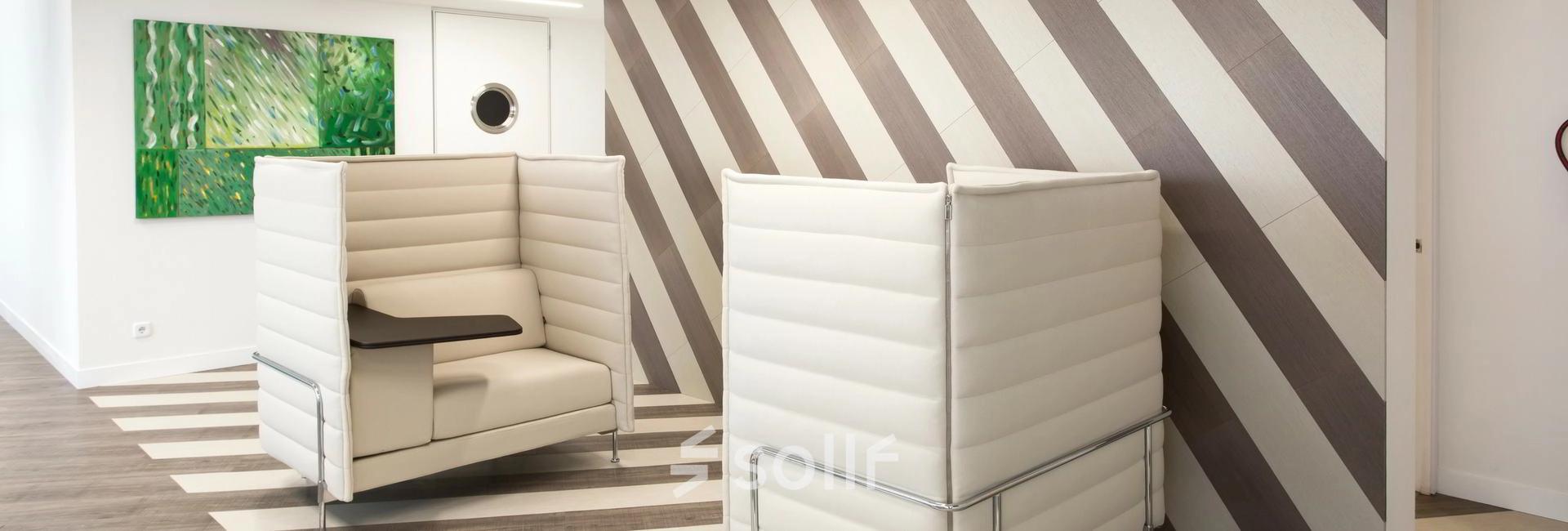 Modern office space with stylish furniture and geometric wall design, ideal for professionals seeking office space rental in Paseo de la Castellana 141, Madrid Azca.
