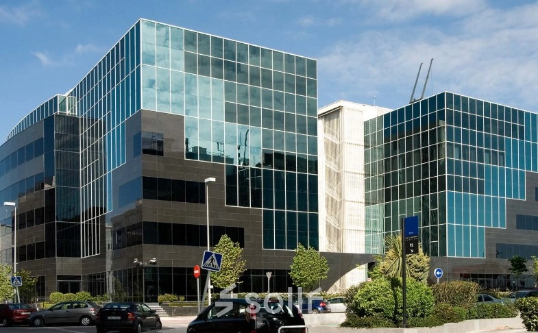 Contemporary glass-fronted office building located on Avenida del Partenón 16-18, offering sleek office space rental in Madrid Barajas.