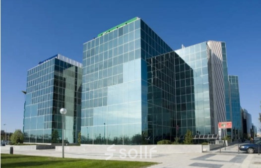 Modern glass office building located at Avenida del Partenón 16-18 in Madrid Barajas, ideal for rent office space with large windows and sleek design.