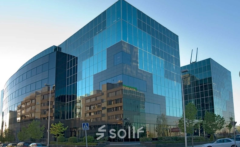 Modern glass office building located at Avenida del Partenón 16-18, Madrid Barajas, available for rent as office space.