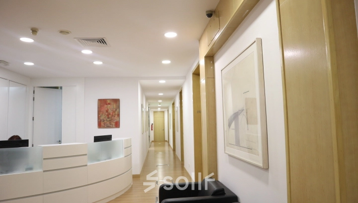 Interior view of office space for rent at Calle Gran Vía 6, Madrid Center, featuring a reception area with modern decor and furnishings.