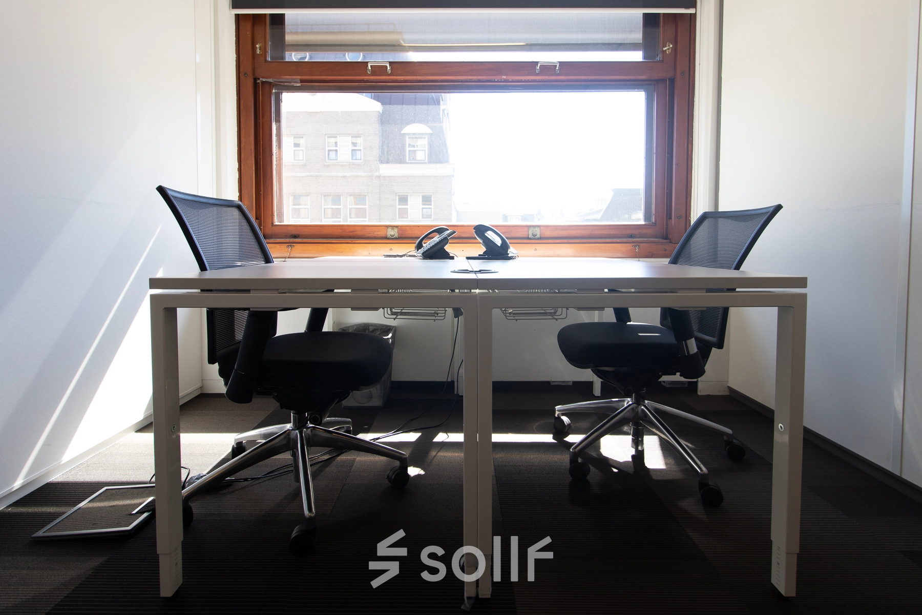 Bright office to rent at Paseo de Recoletos 5, Madrid Recoletos, featuring two chairs and a desk under a large window.