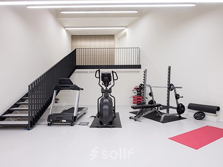 Office space rental at Kardinaal Mercierplein 2 in Mechelen Centrum featuring a minimalist gym setup with exercise equipment.