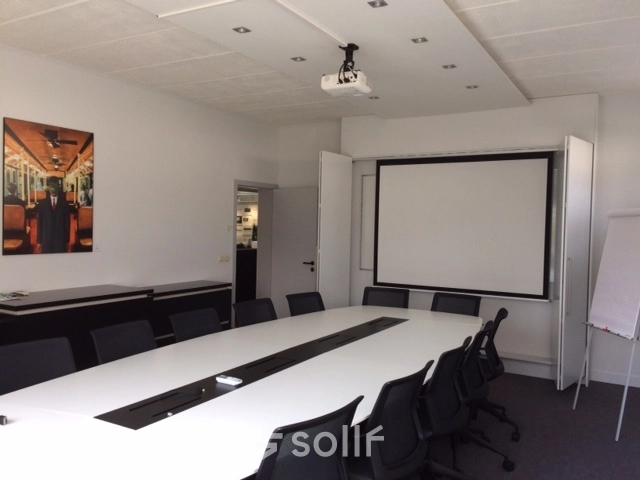 Modern conference room with long table and chairs available for office space rental in Mechelen North.