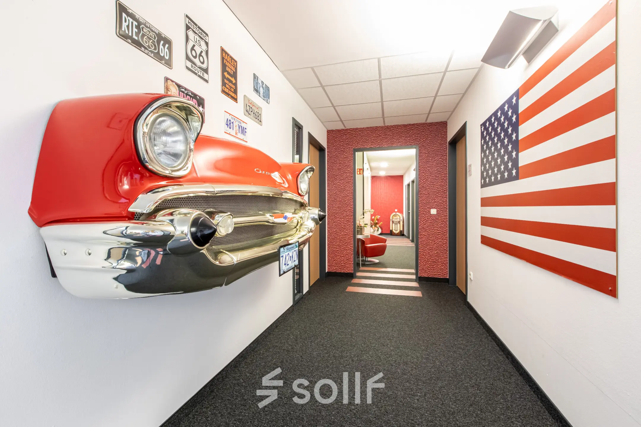 Hallway featuring retro car hood and American flag details, offering a creative office space rental style.