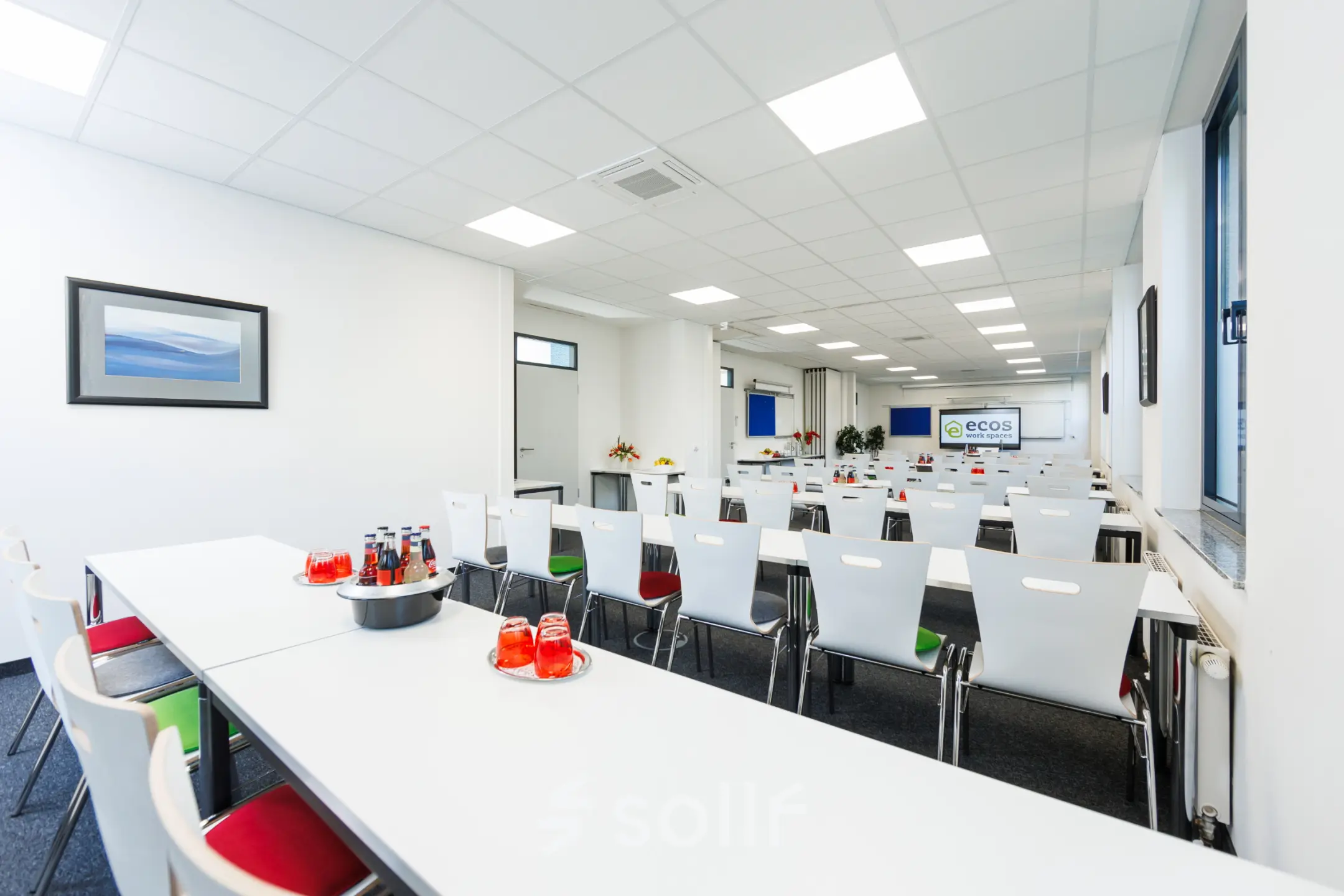 Spacious Munich Laim office at Landsberger Straße 155, featuring rows of tables and chairs, perfect for office space rental or events.
