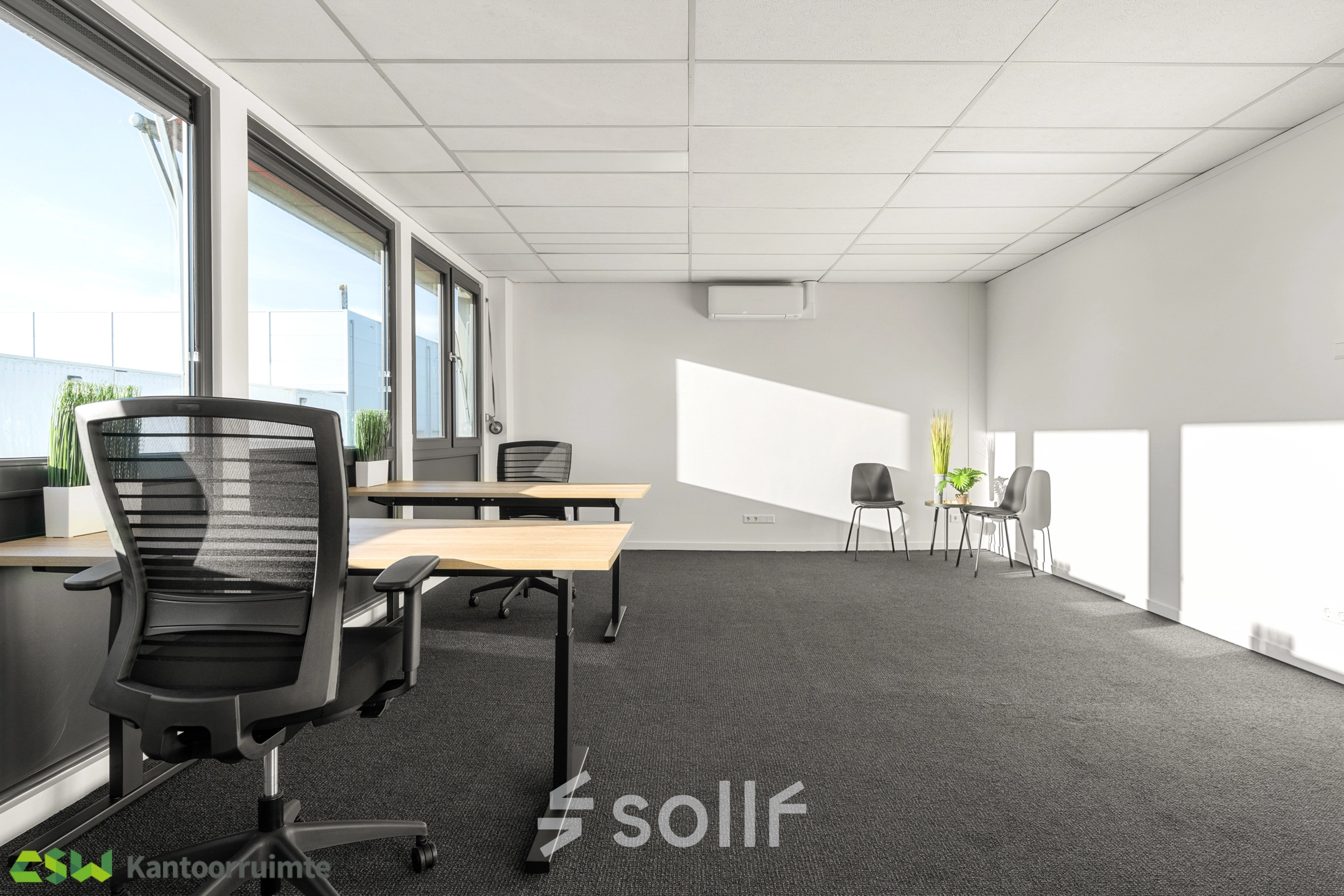 Bright office space with large windows, featuring desks and chairs, perfect for an office space rental at Nijverheidsweg 9B, Nieuwegein.