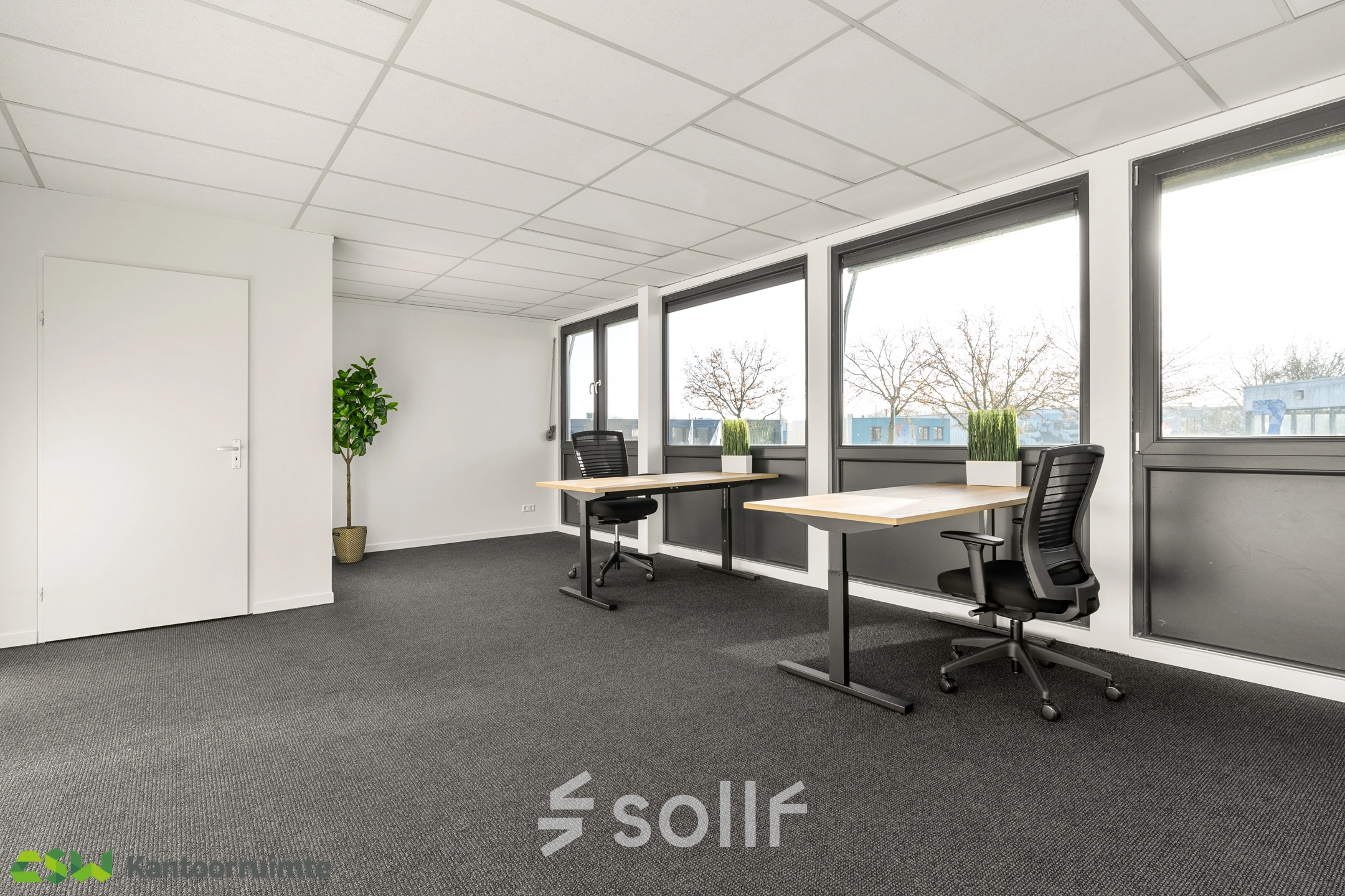 Bright and empty office space with large windows and two desks, available for office space rental at Nijverheidsweg 9B, Nieuwegein.