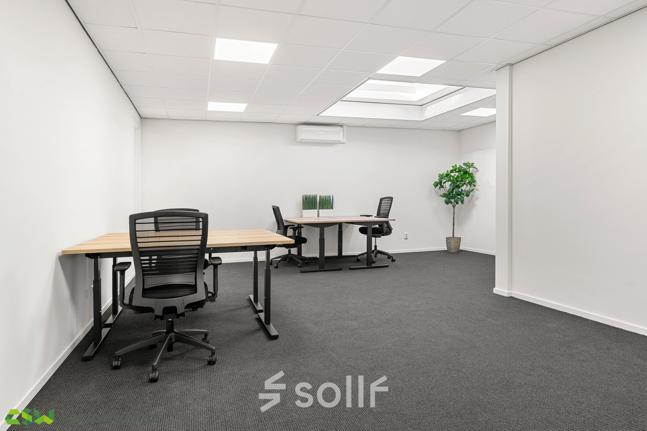 Modern office space for rent at Nijverheidsweg 9B, Nieuwegein, featuring desks, chairs, and a potted plant under skylights for bright natural lighting.