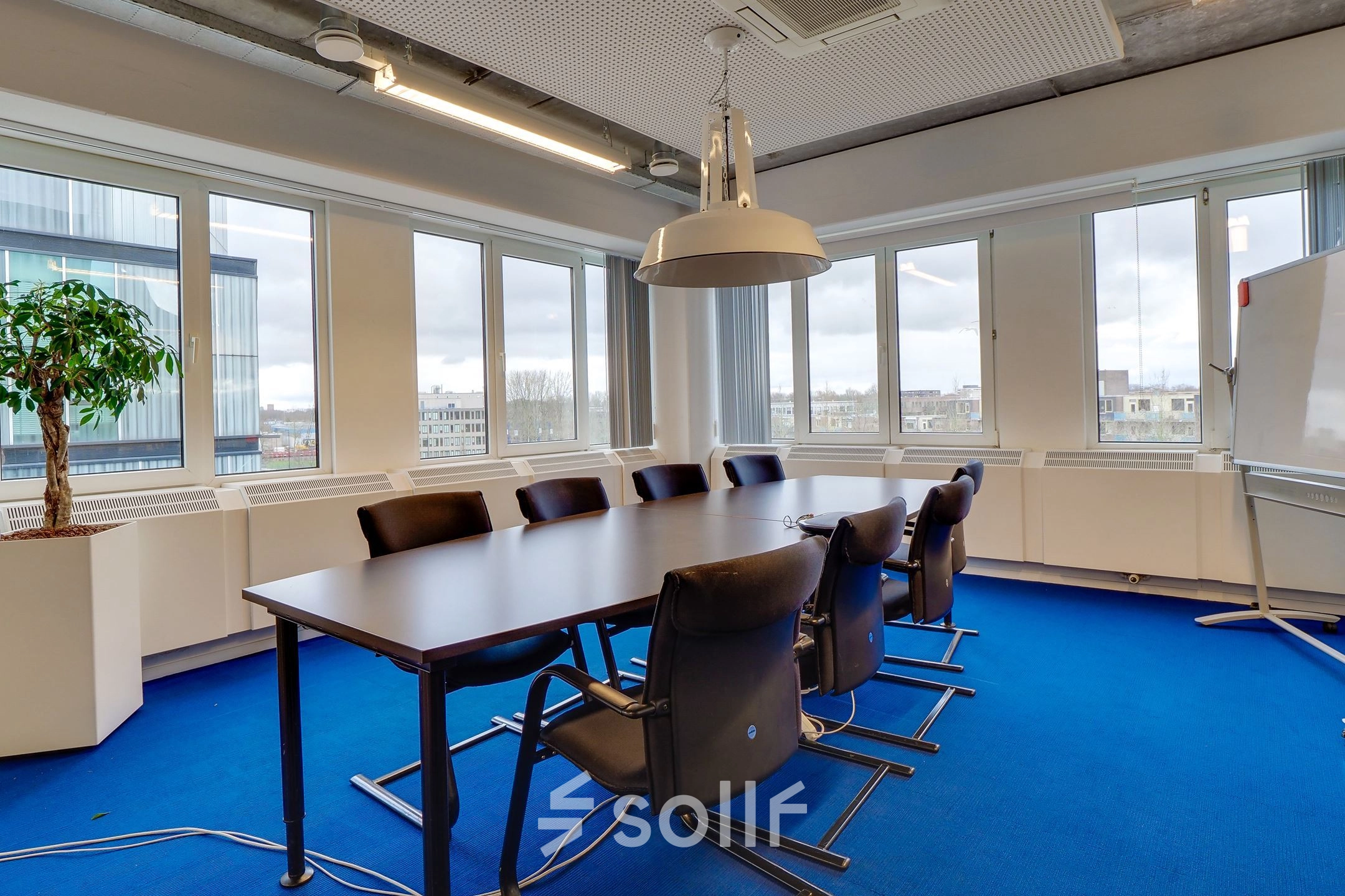 Spacious conference room at Zoomstede 19, Nieuwegein, featuring a large table, chairs, and ample natural light, ideal for office space rental.