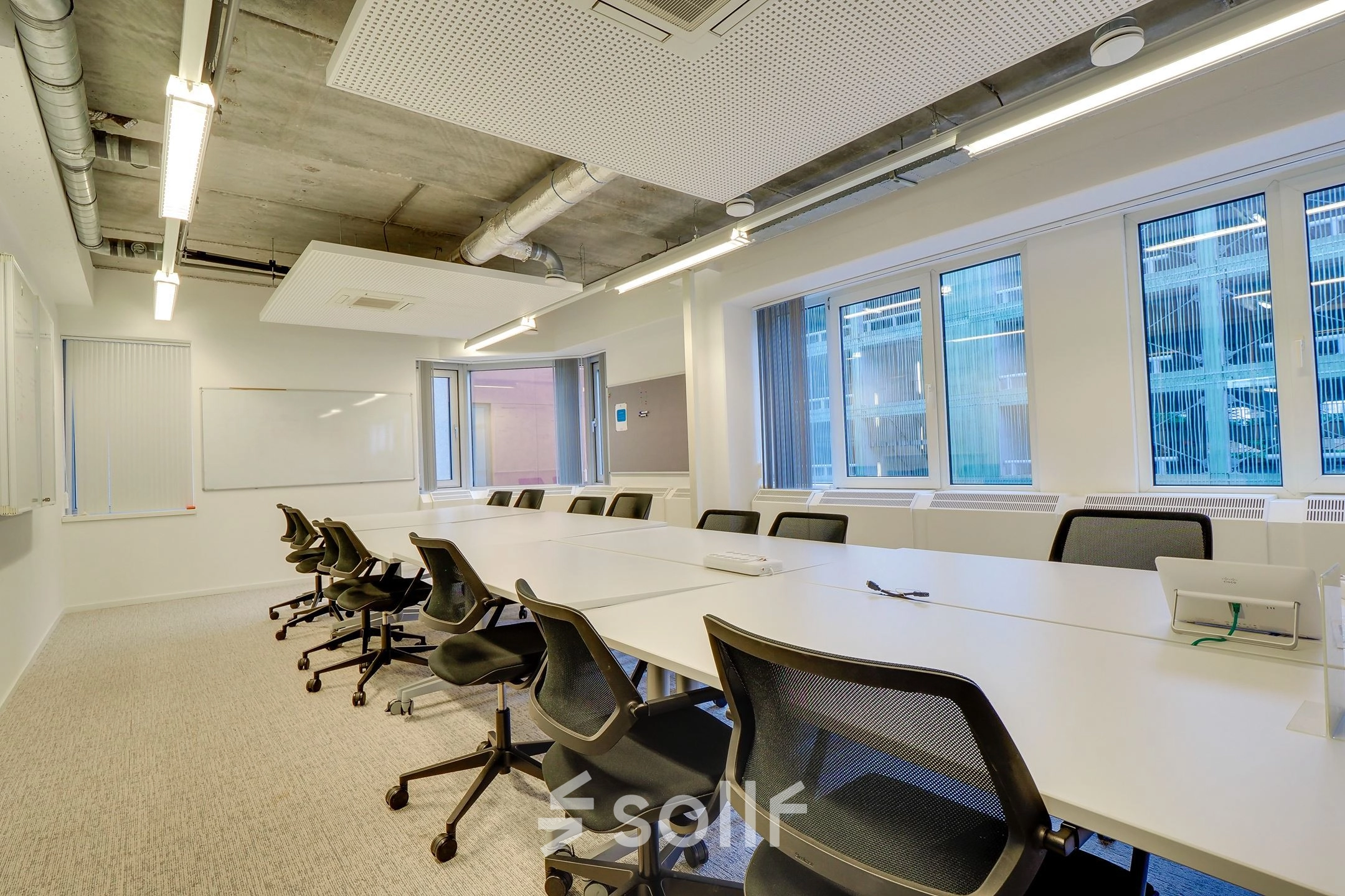 Spacious, modern conference room at Zoomstede 19, Nieuwegein featuring a long table surrounded by ergonomic chairs and large windows for natural light, ideal for office space rental.