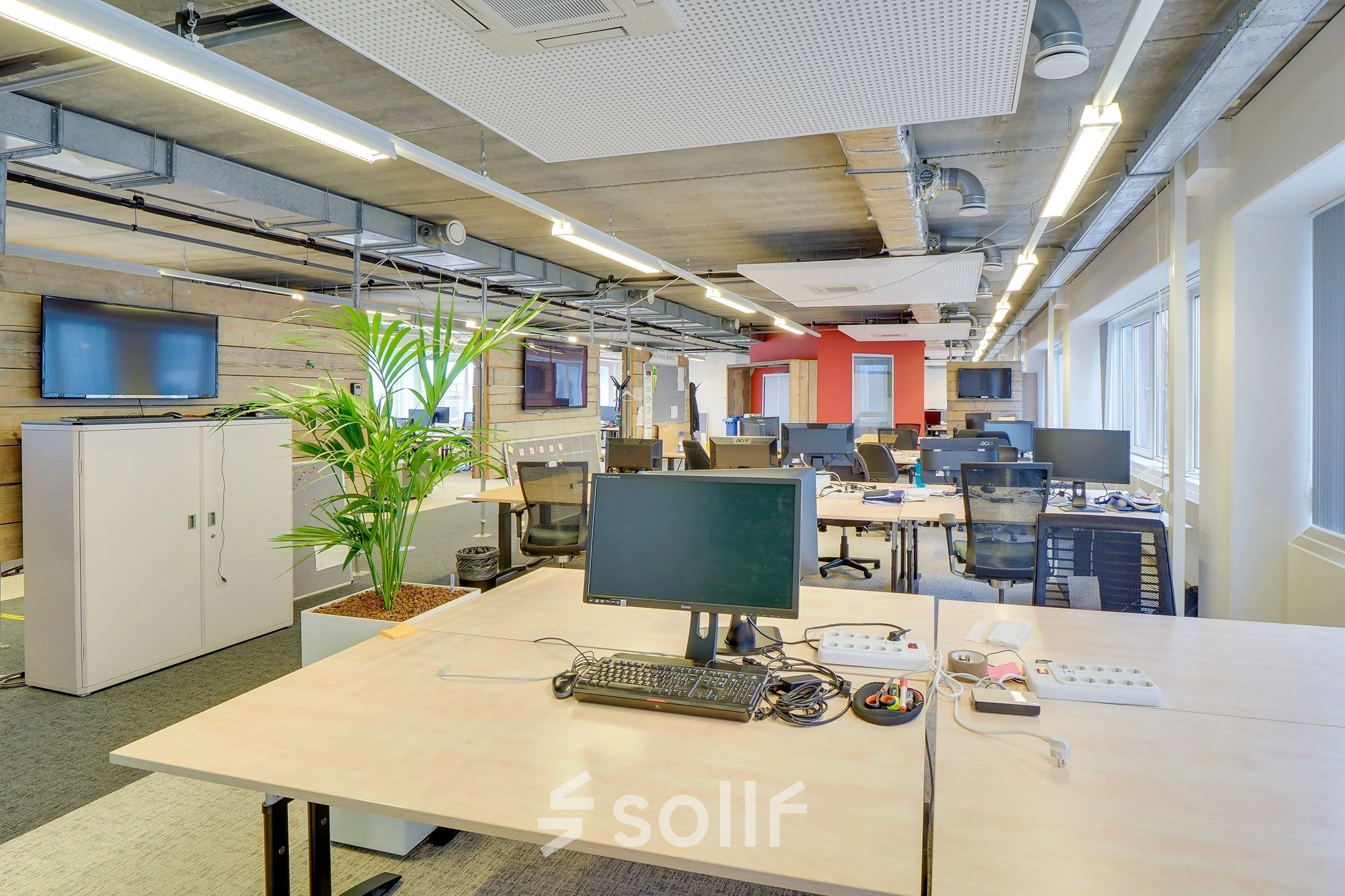 A spacious office interior on Zoomstede 19, Nieuwegein, featuring open workspaces with multiple desks, computer monitors, and a potted plant under modern lighting. Ideal for office space rental.