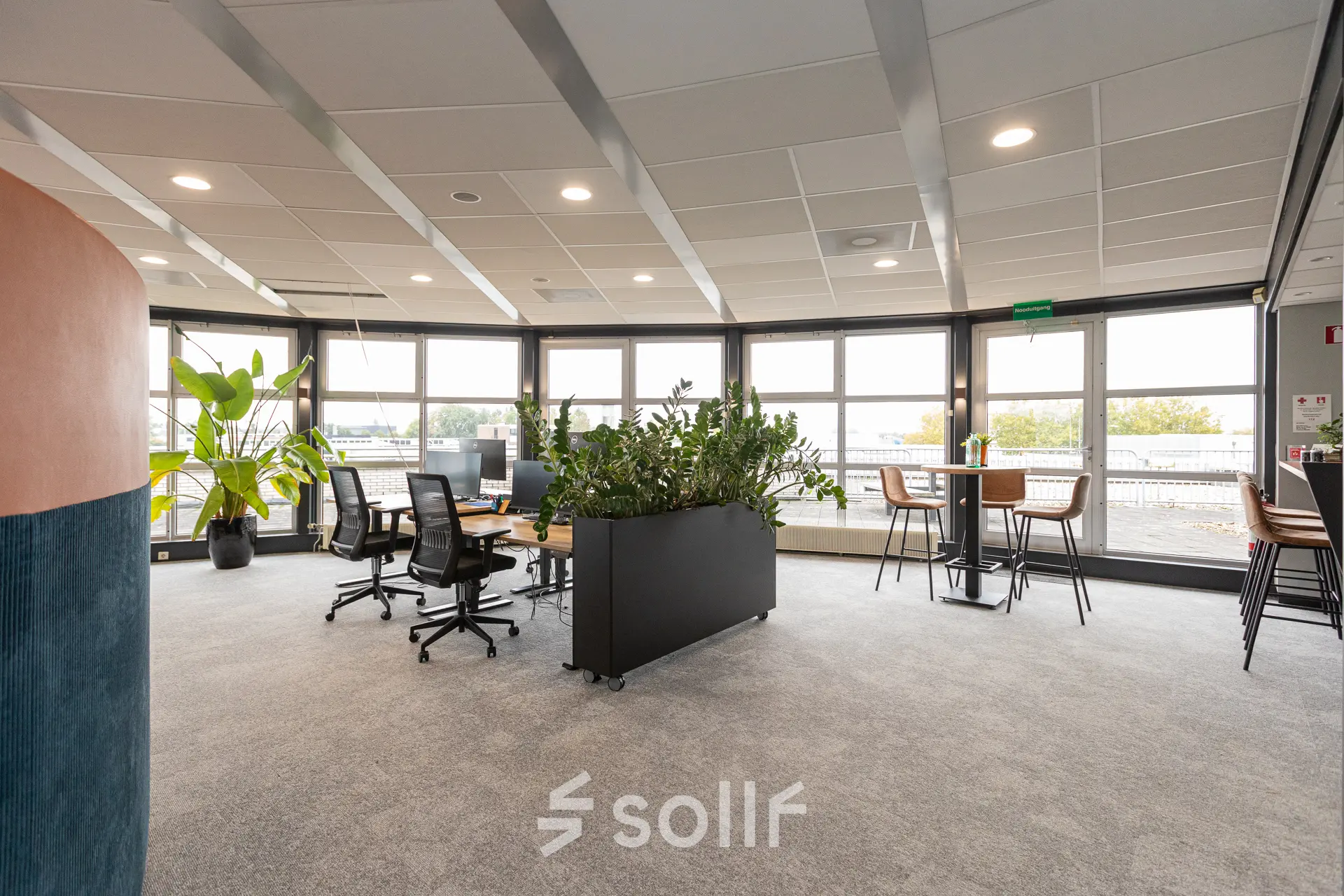Bright office space with modern furnishings at Patroonstraat 13, Nijkerk, available for rent. Features large windows, ergonomic chairs, and desks ideal for business activities.