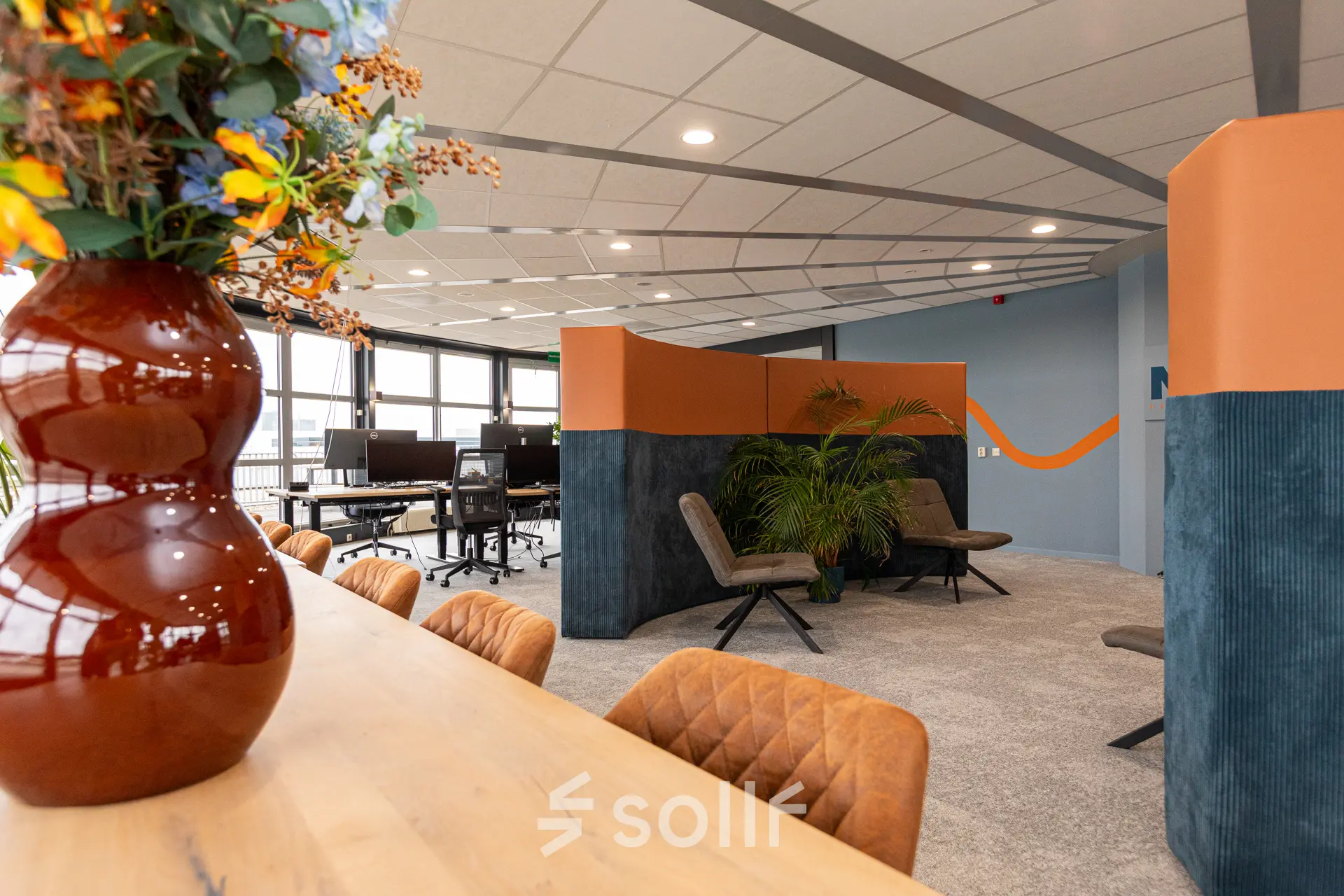 Interior view of furnished office space at Patroonstraat 13, Nijkerk, featuring modern chairs, tables, and vibrant decor ideal for office space rental.