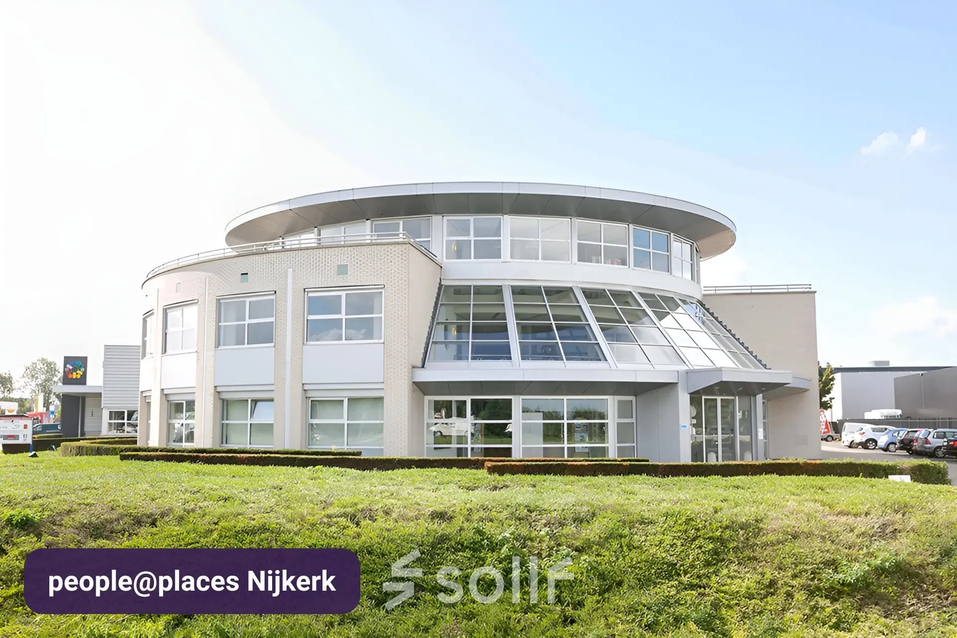 Modern office building at Patroonstraat 13 in Nijkerk available for office space rental, featuring a unique curved facade and ample windows.