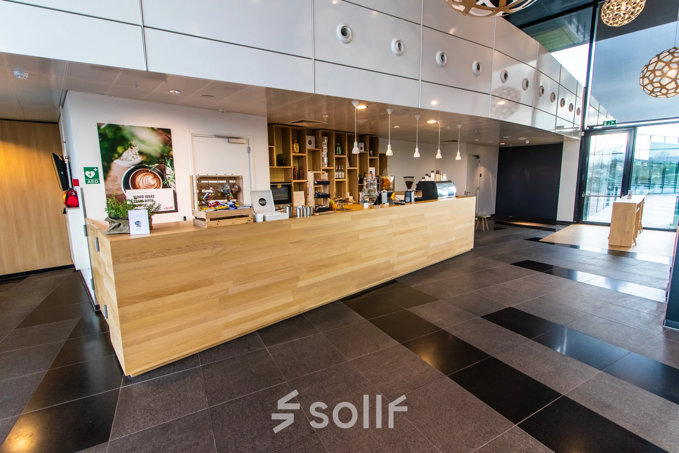 Modern office space at Jonkerbosplein 52, Nijmegen features a sleek wooden counter ideal for a reception area, available for rent as part of attractive office space rental offerings.