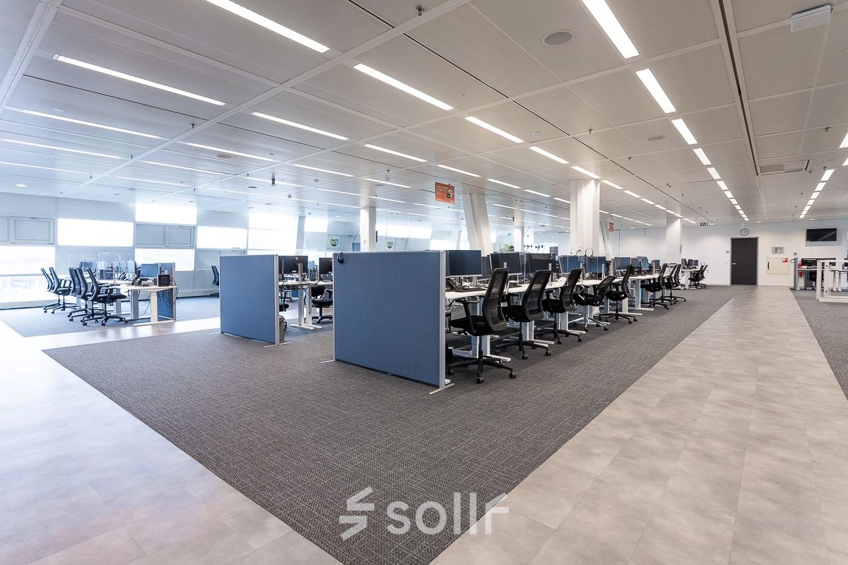 Spacious office space with rows of desks and chairs at Jonkerbosplein 52, ideal for those looking to rent office space in Nijmegen.