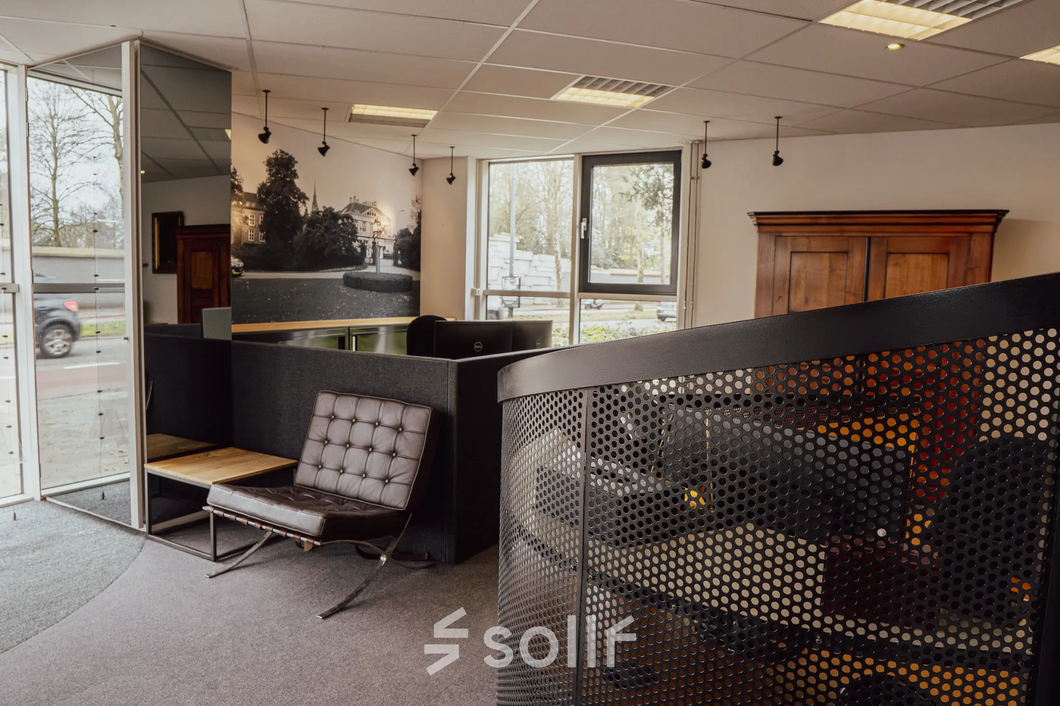 Office space with modern furniture and a spiral staircase, suitable for rental at Abdis van Thornstraat 74, Oosterhout Nb.