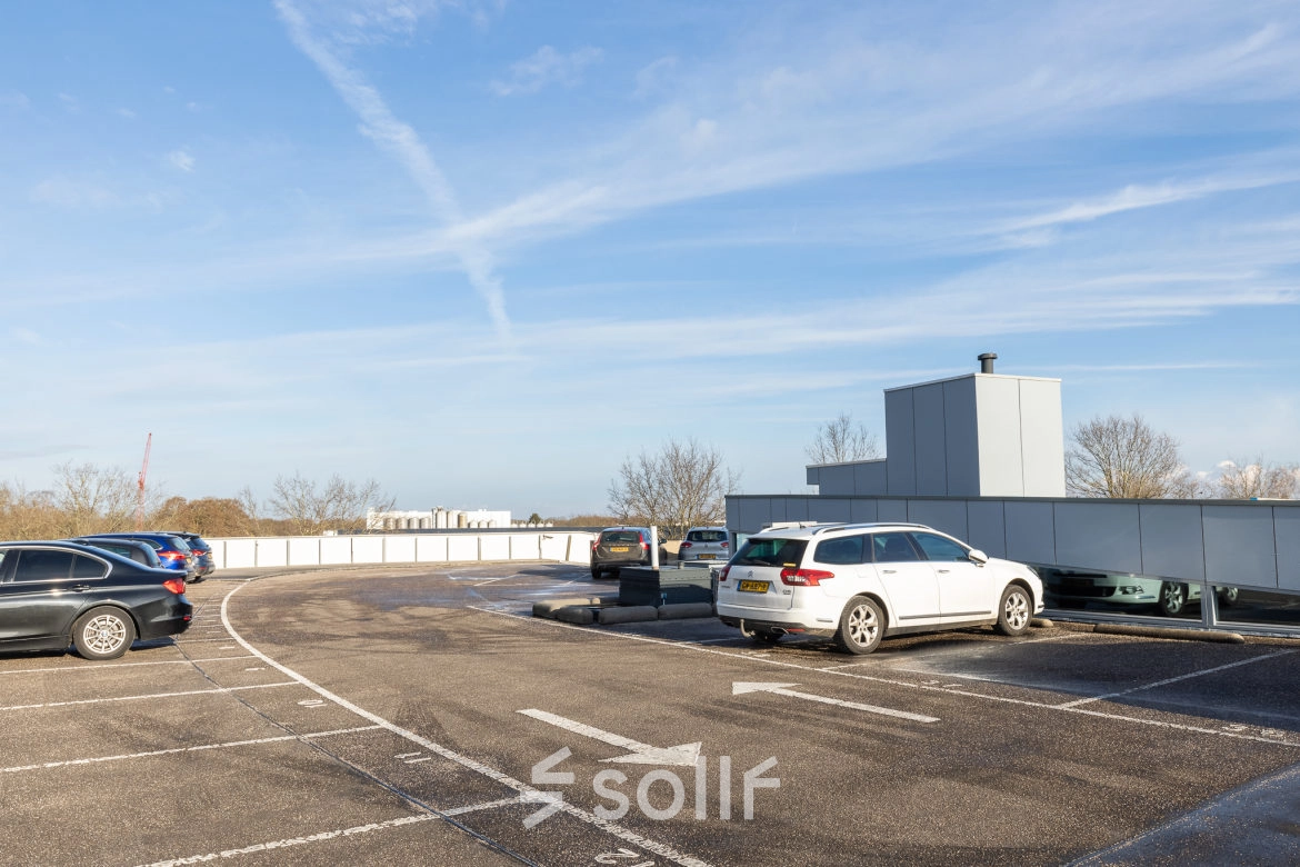 Parking area at Veengang 1, Oosterwolde, offering convenient access to rent office space in the building.