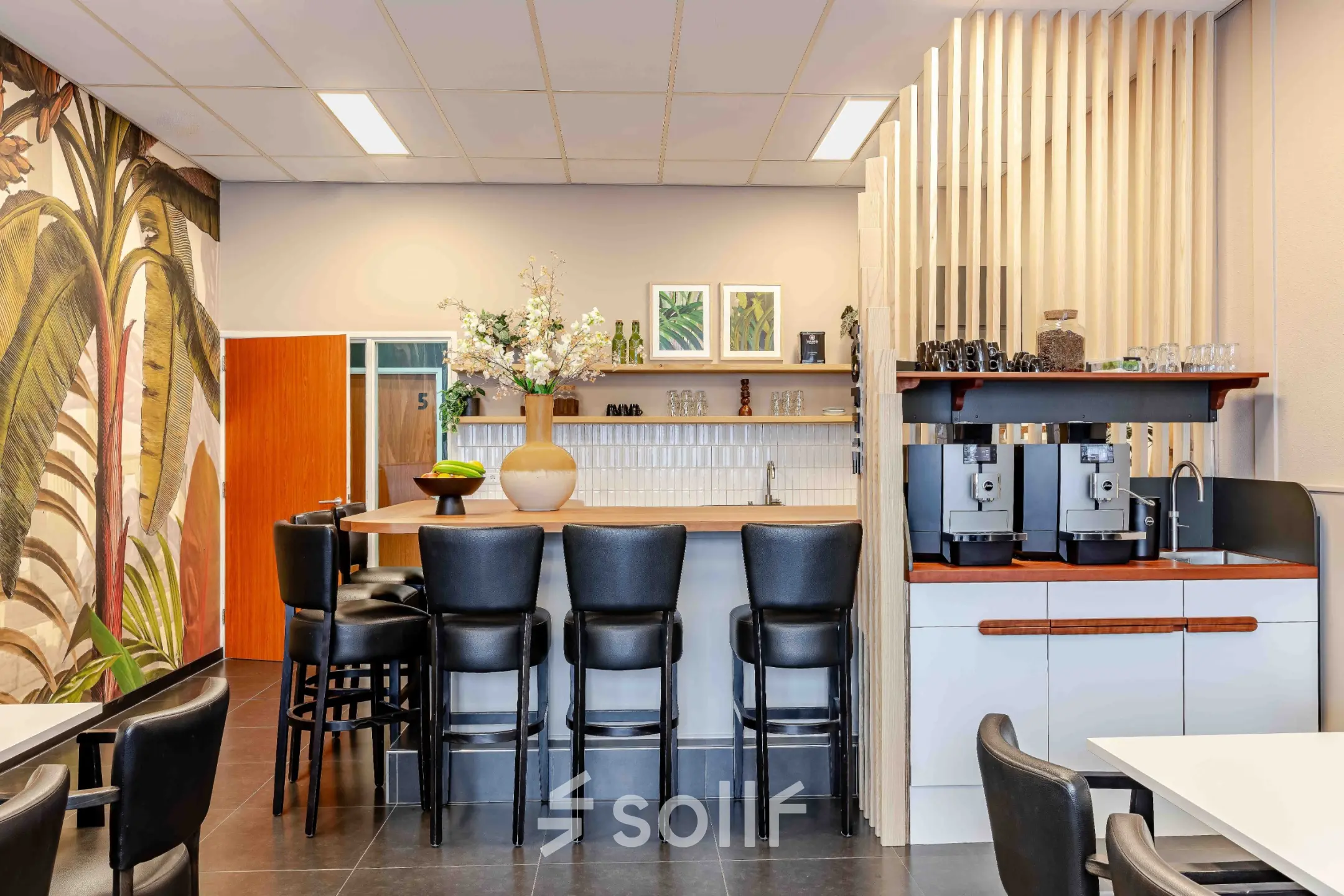 Modern furnished lounge area in an office at Leeghwaterstraat 25, Reeuwijk, with bar seating and modern decor.