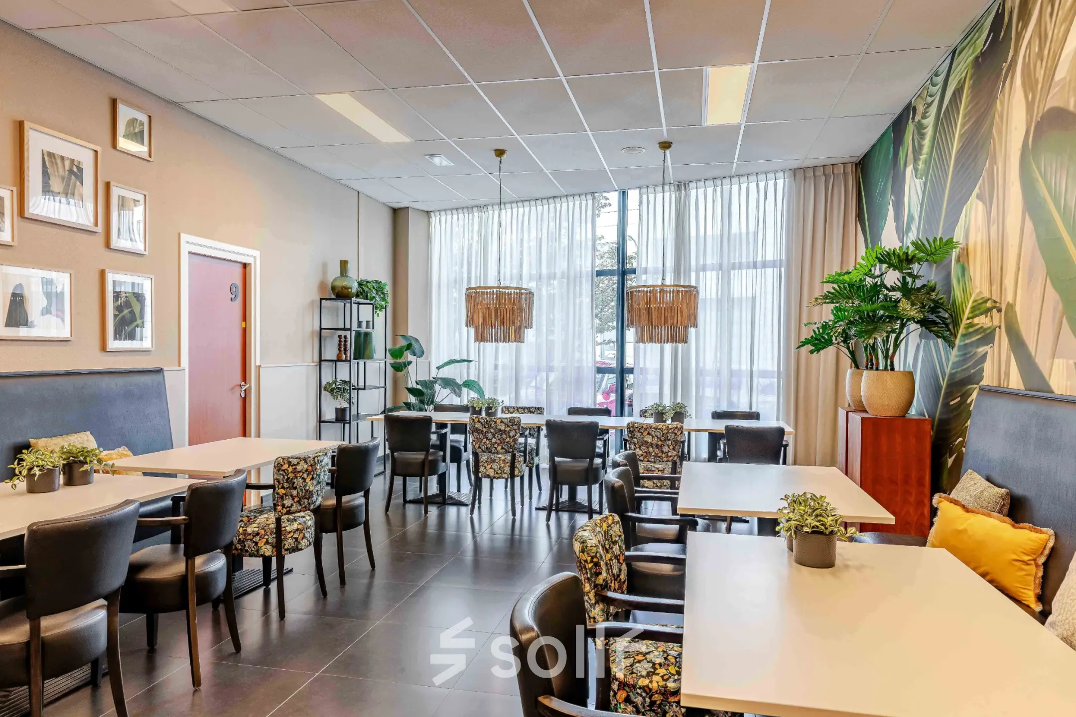 Interior of a furnished lounge area with tables and chairs at Leeghwaterstraat 25, ideal for office space rental.