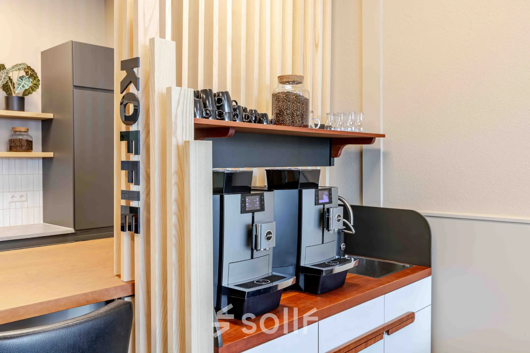 Coffee station with modern machines and wooden accents, ideal for an office space rental at Leeghwaterstraat 25, Reeuwijk.