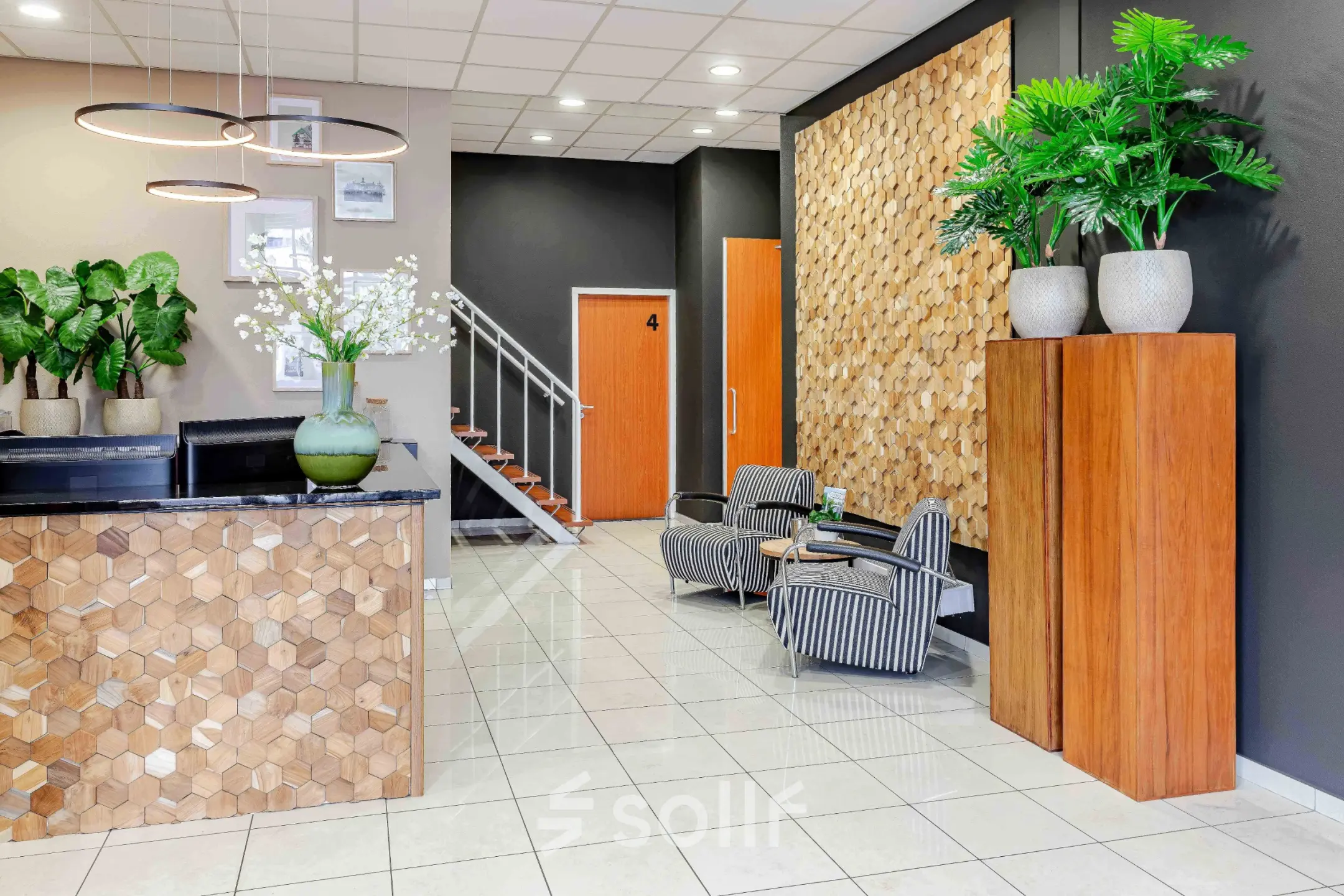 Bright and inviting entrance at Leeghwaterstraat 25, Reeuwijk with modern decor and plants, ideal for renting office space.