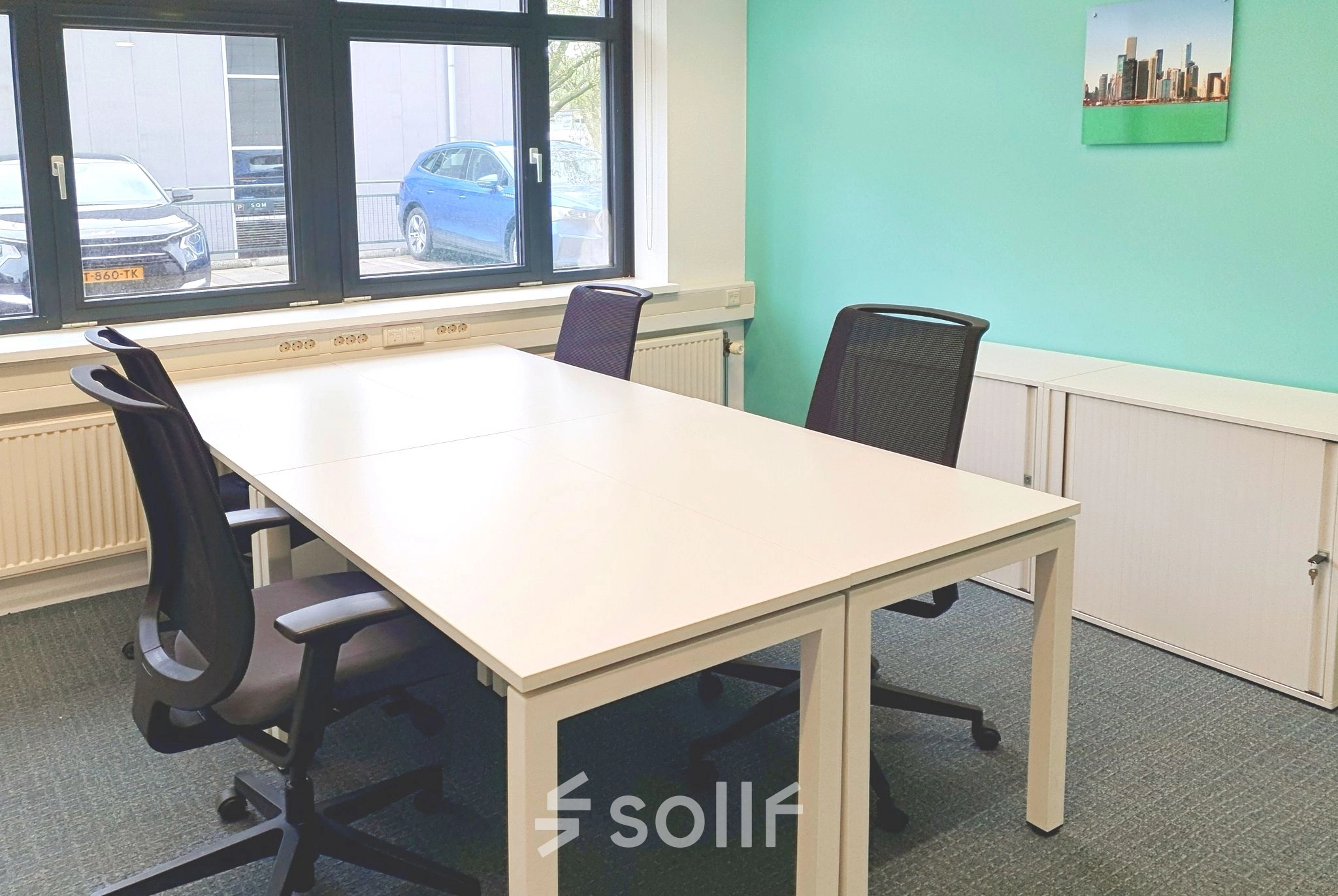 Bright office space at Einsteinlaan 28, Rijswijk, with modern furnishings perfect for office space rental, featuring a large window and ample seating options.