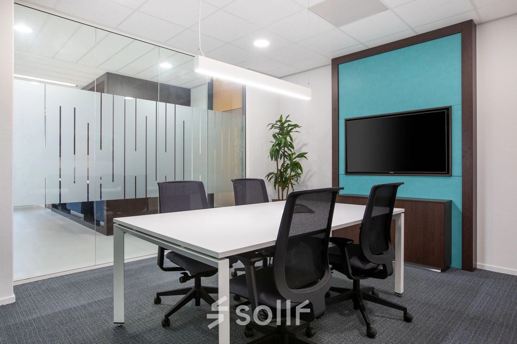 Modern furnished conference room at Einsteinlaan 28, Rijswijk, featuring a sleek table, comfortable chairs, and a wall-mounted screen, suitable for office space rental.