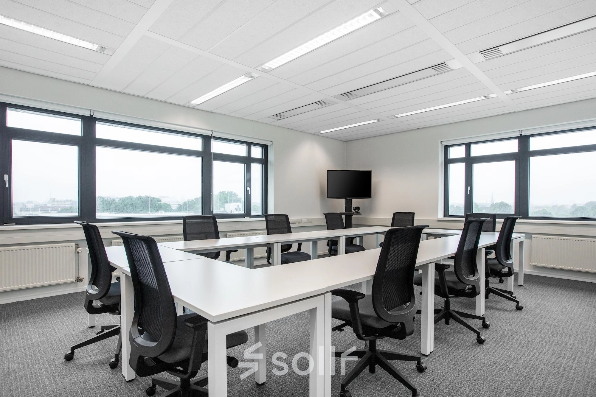 Office space rental at Einsteinlaan 28, Rijswijk, featuring a furnished room with a long table and chairs, perfect for group meetings or collaborative work.