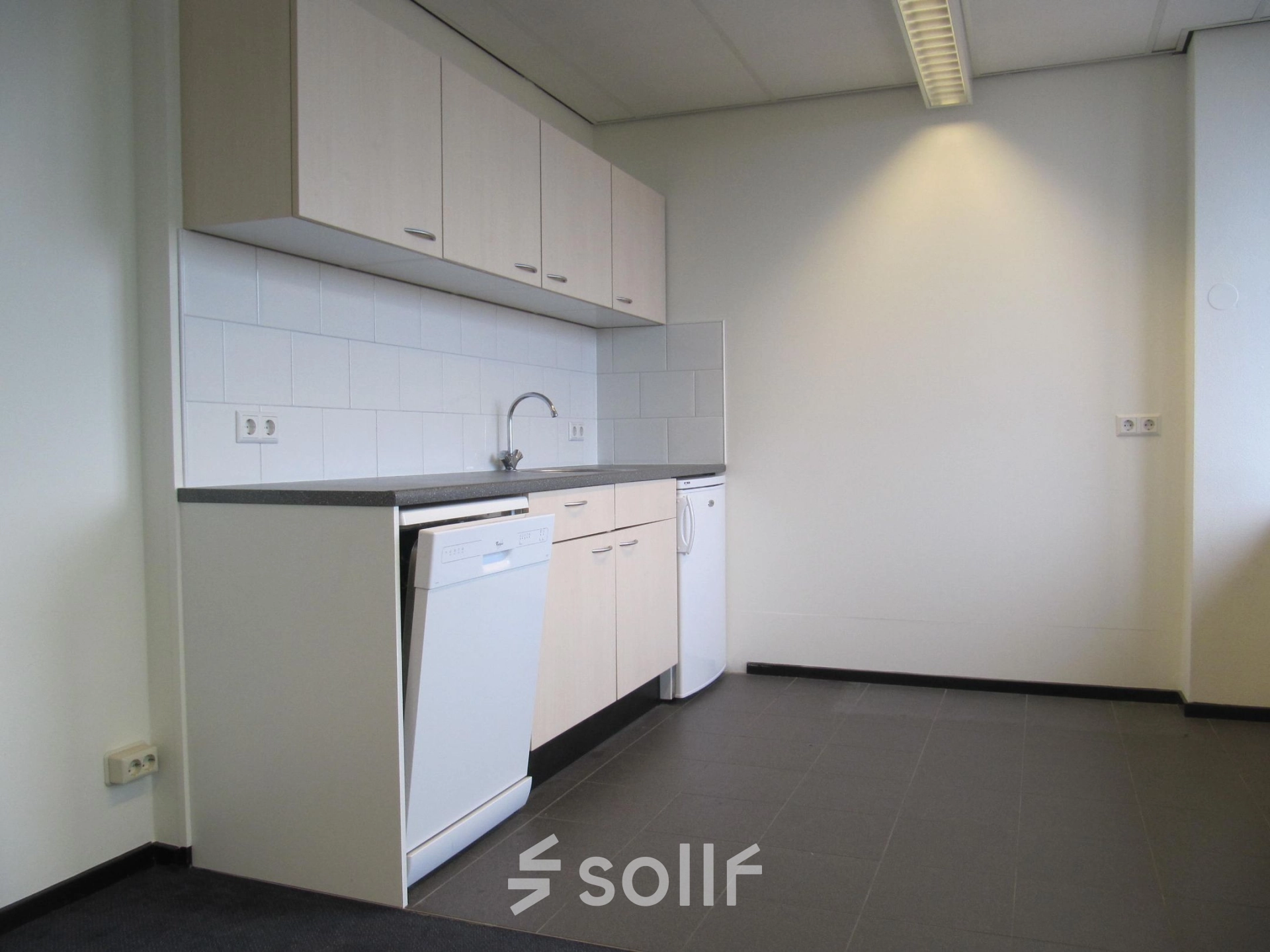 Bright office pantry available for rent at JC van Markenlaan 3, Rijswijk, featuring modern cabinetry and tile flooring.