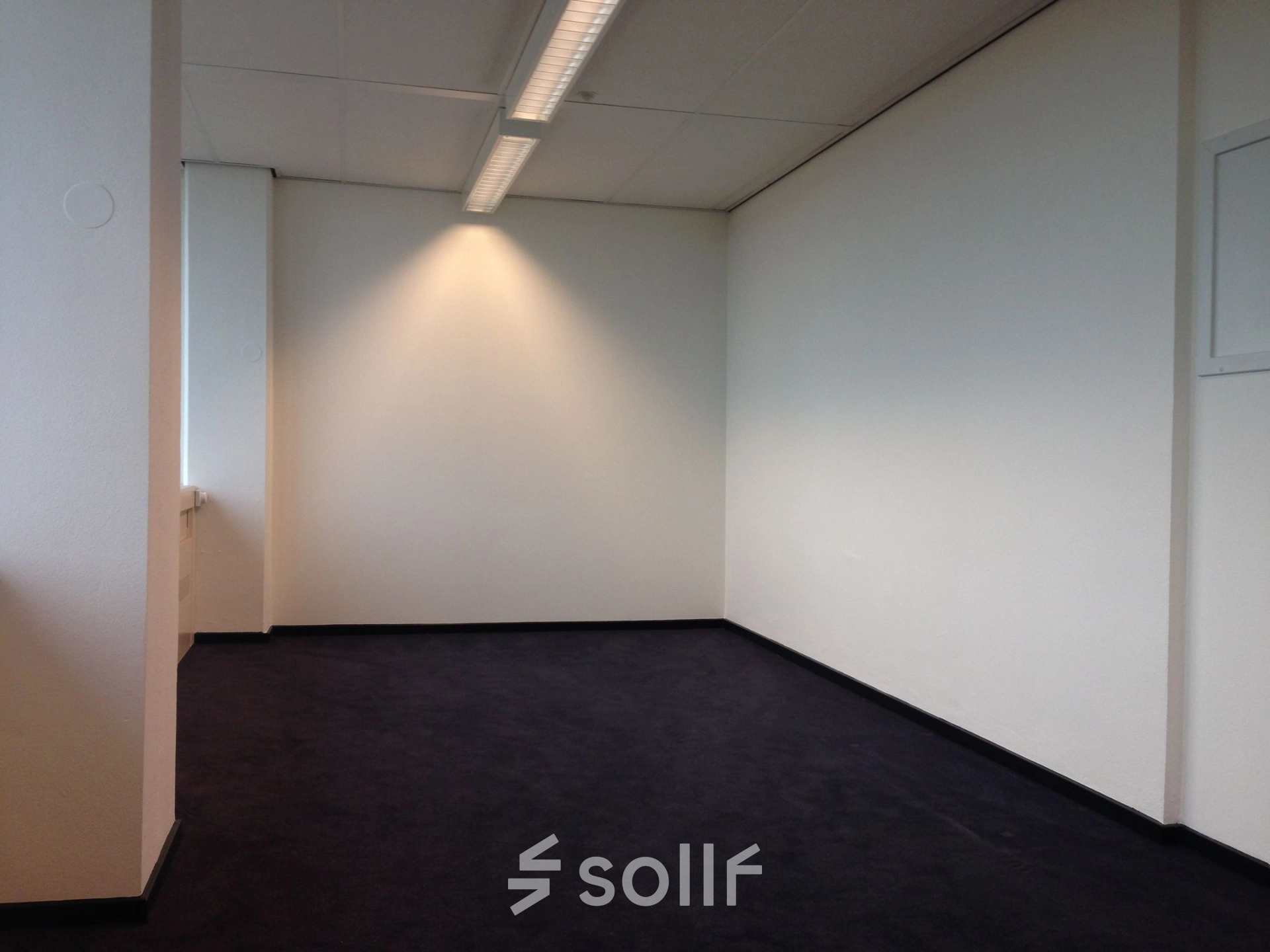 Minimalist office space at JC van Markenlaan 3, Rijswijk, available for rent. The room features a neutral palette and ample lighting, ideal for office space rental.