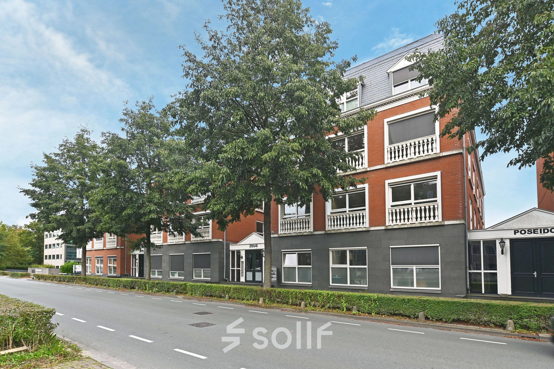 Exterior view of office building at Laan van Vredenoord 17-19 in Rijswijk, surrounded by trees, perfect for office space rental.