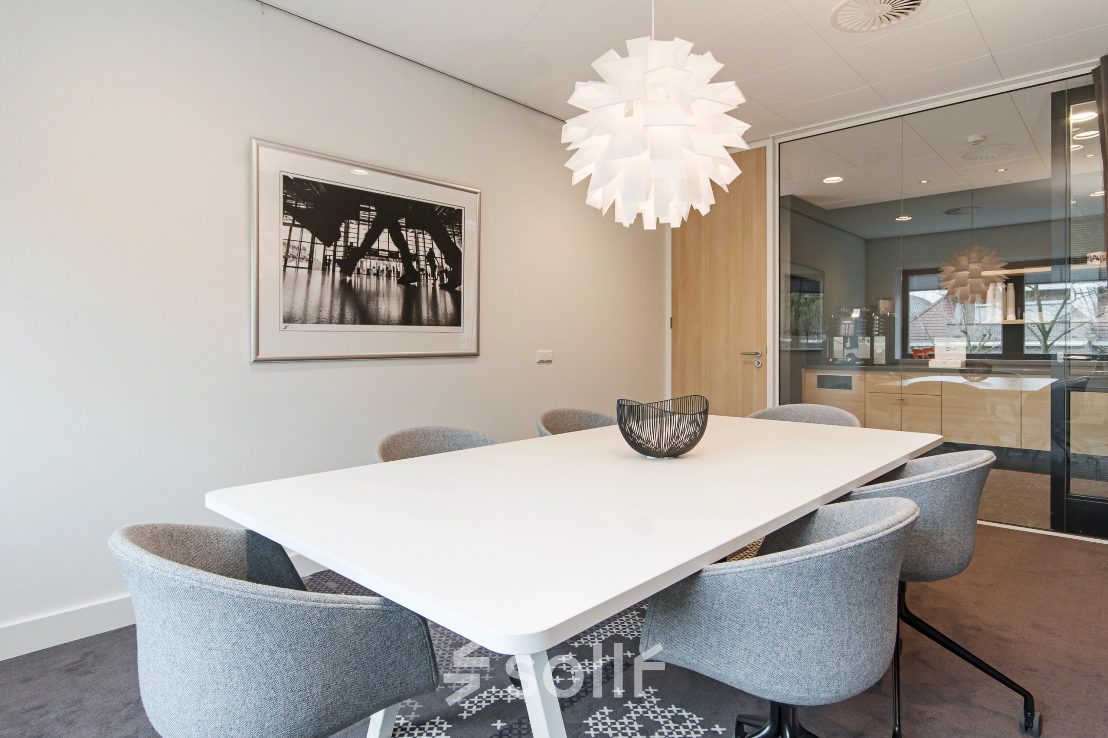 Furnished conference room at Laan van Vredenoord 33, Rijswijk, featuring a modern table and chairs, suitable for office space rental.