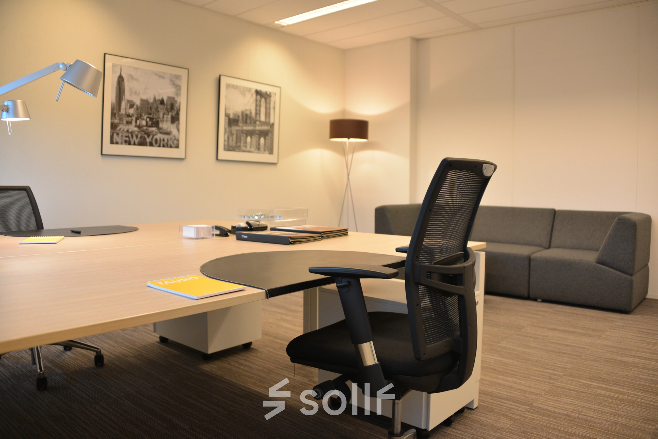 Interior of a furnished office at Laan van Vredenoord 33, Rijswijk, featuring a desk, a chair, and a comfortable sofa. Ideal for office space rental with modern amenities.