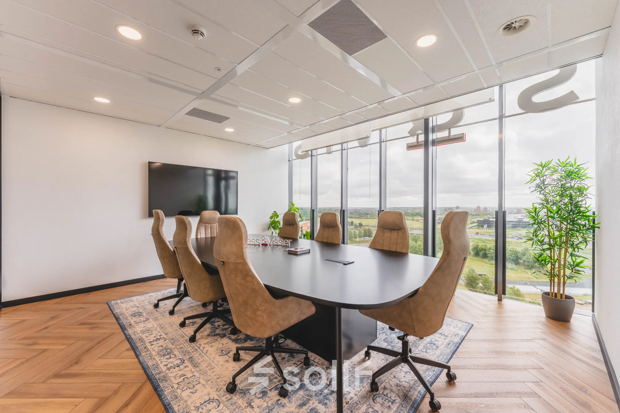Modern conference room with a large table and chairs, overlooking a scenic view, ideal for office space rental at Laan van Zuid Hoorn 70, Rijswijk.